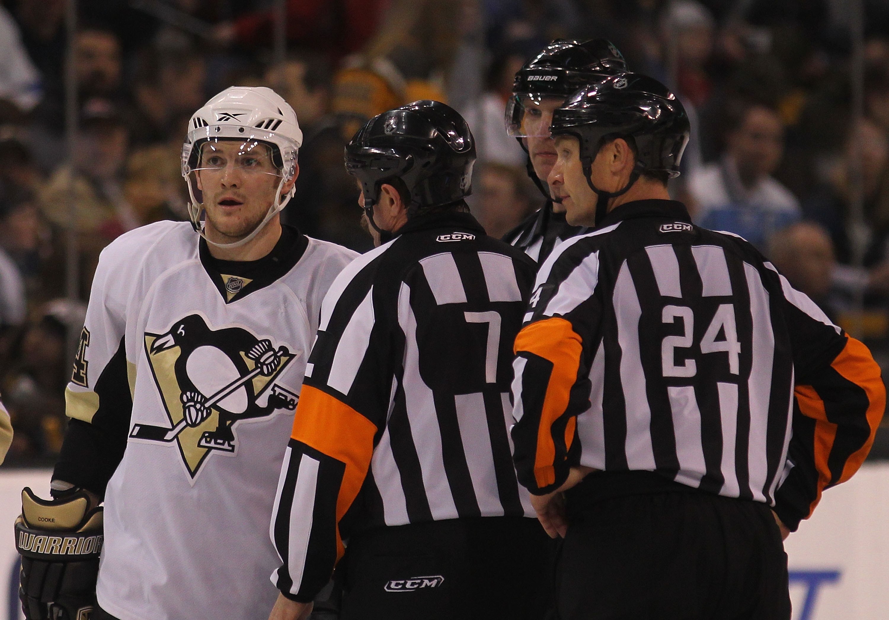 BOSTON - MARCH 18: Matt Cooke #24 of the Pittsburgh Penguins is spoken to by referees Bill McCreary #7 and Stephen Walkom #24 in his game against the Boston Bruins at the TD Garden on March 18, 2010 in Boston, Massachusetts.  (Photo by Bruce Bennett/Getty