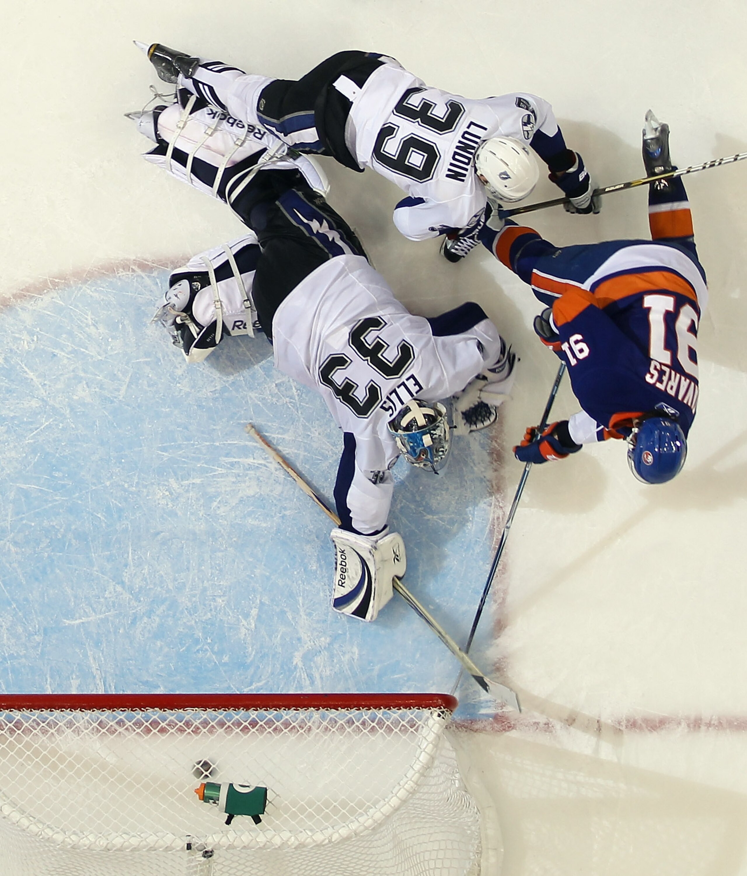 UNIONDALE, NY - DECEMBER 22:  John Tavares #91 of the New York Islanders scores the winning goal in overtime against Dan Ellis #33 of the Tampa Bay Lightning at the Nassau Coliseum on December 22, 2010 in Uniondale, New York. (Photo by Bruce Bennett/Getty
