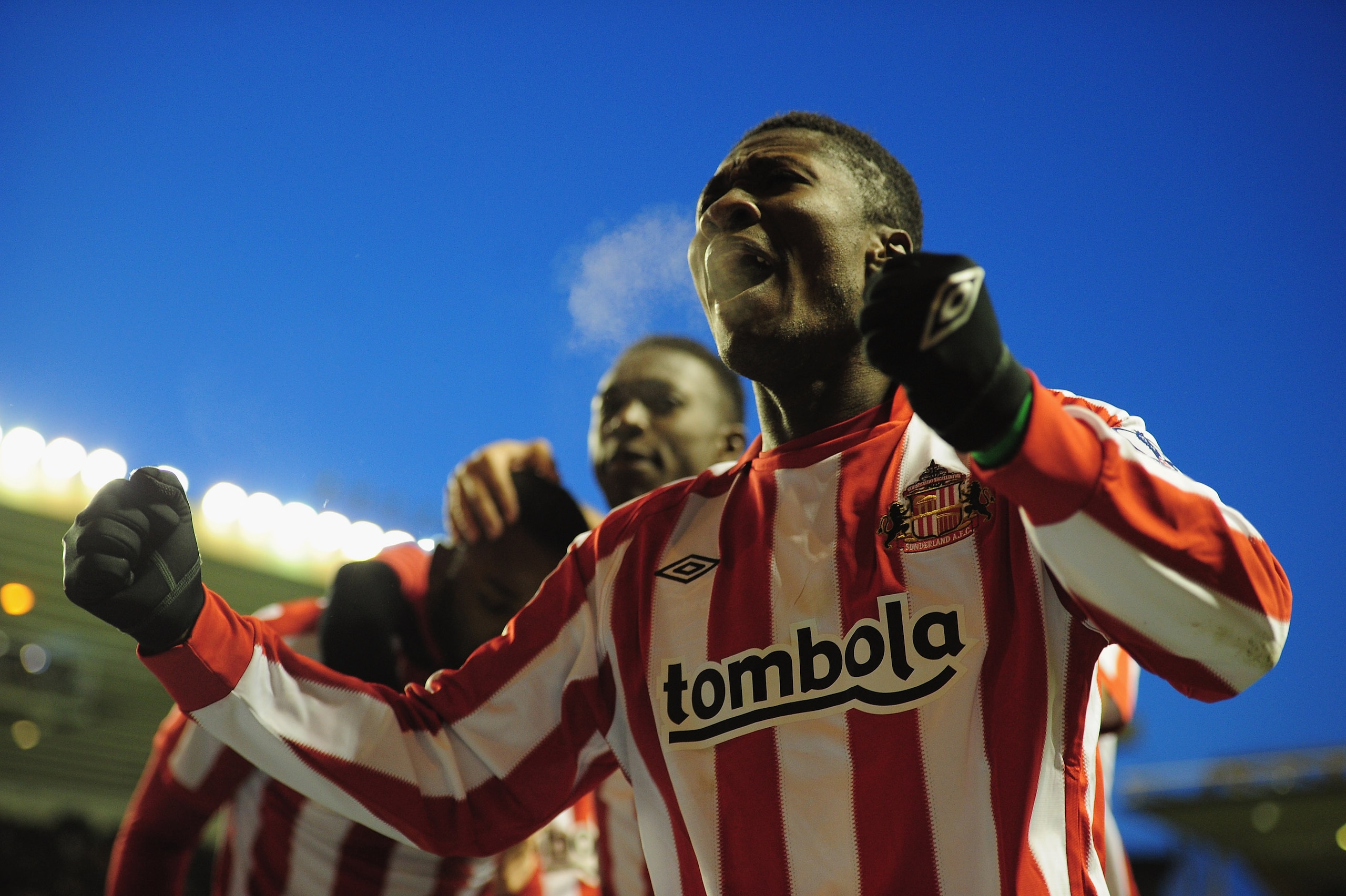 WOLVERHAMPTON, ENGLAND - NOVEMBER 27:  Asamoah Gyan of Sunderland celebrates after team-mate Darren Bent scores during the Barclays Premier League match between Wolverhampton Wanderers and Sunderland at Molineux on November 27, 2010 in Wolverhampton, Engl