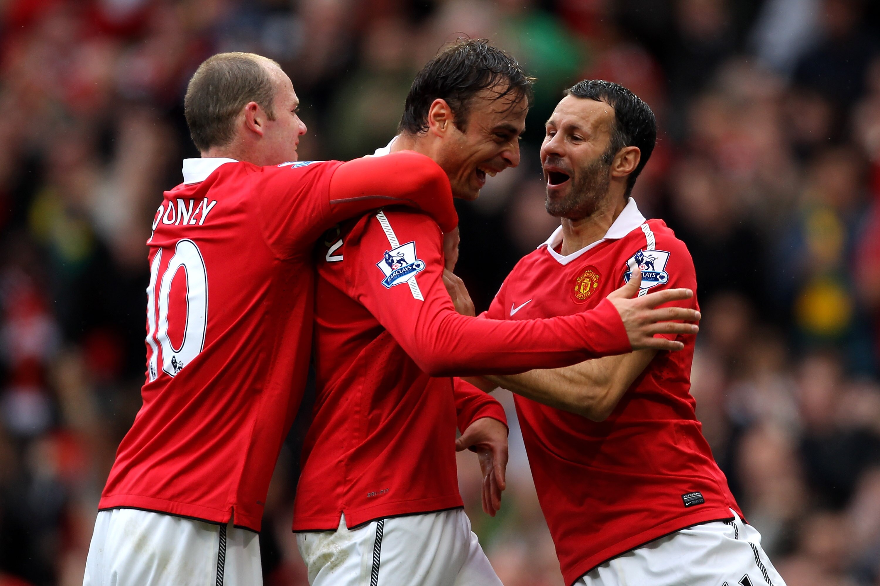 MANCHESTER, ENGLAND - SEPTEMBER 19:  Dimitar Berbatov of Manchester United celebrates scoring his team's second goal with team mates Wayne Rooney and Ryan Giggs (R) during the Barclays Premier League match between Manchester United and Liverpool at Old Tr