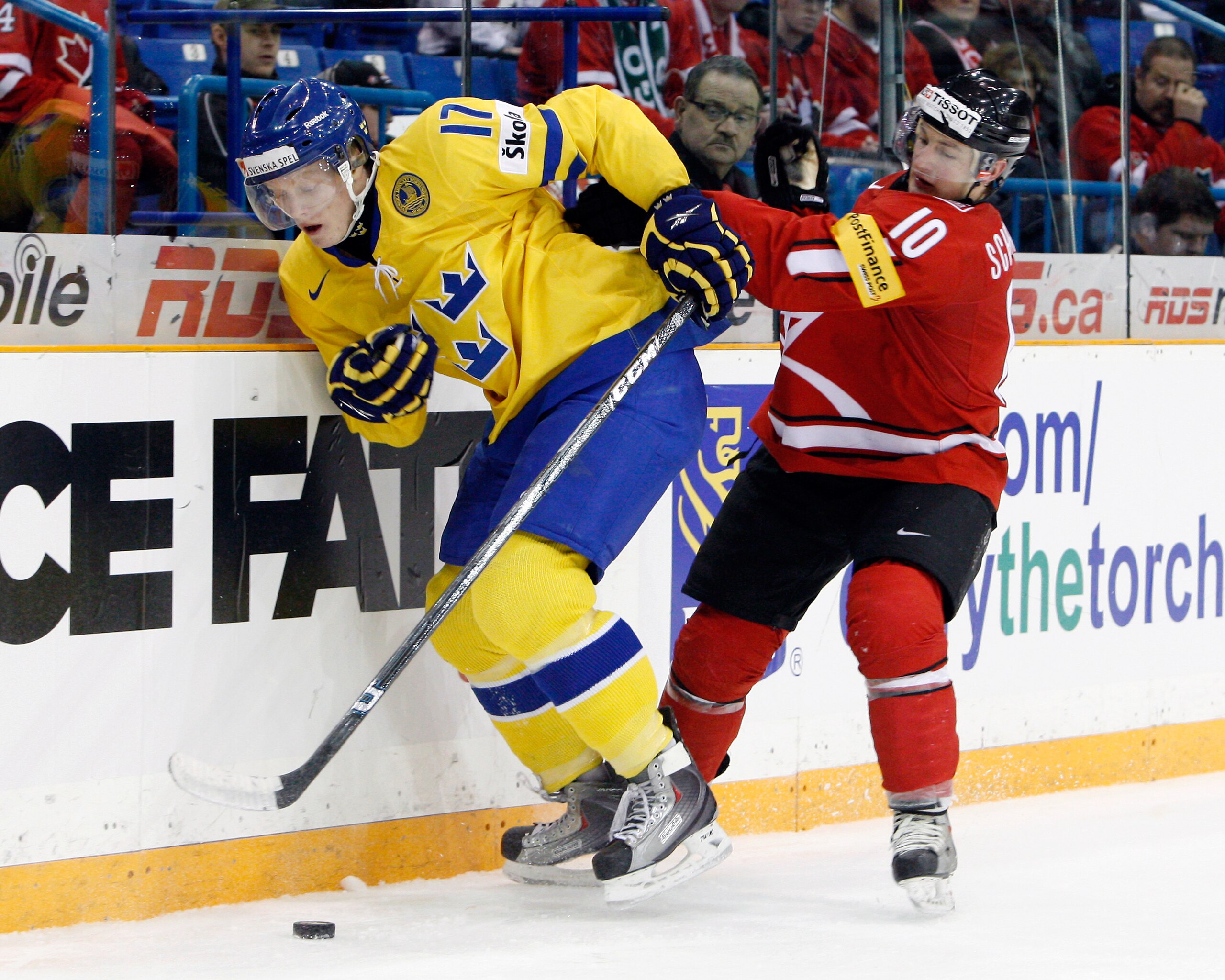 SASKATOON, SK - JANUARY 5:  Carl Klingberg #17 of Team Sweden skates with the puck while being chased by Tristan Scherwey #10 of Team Switzerland during the 2010 IIHF World Junior Championship Tournament Bronze Medal game on January 5, 2010 at the Credit