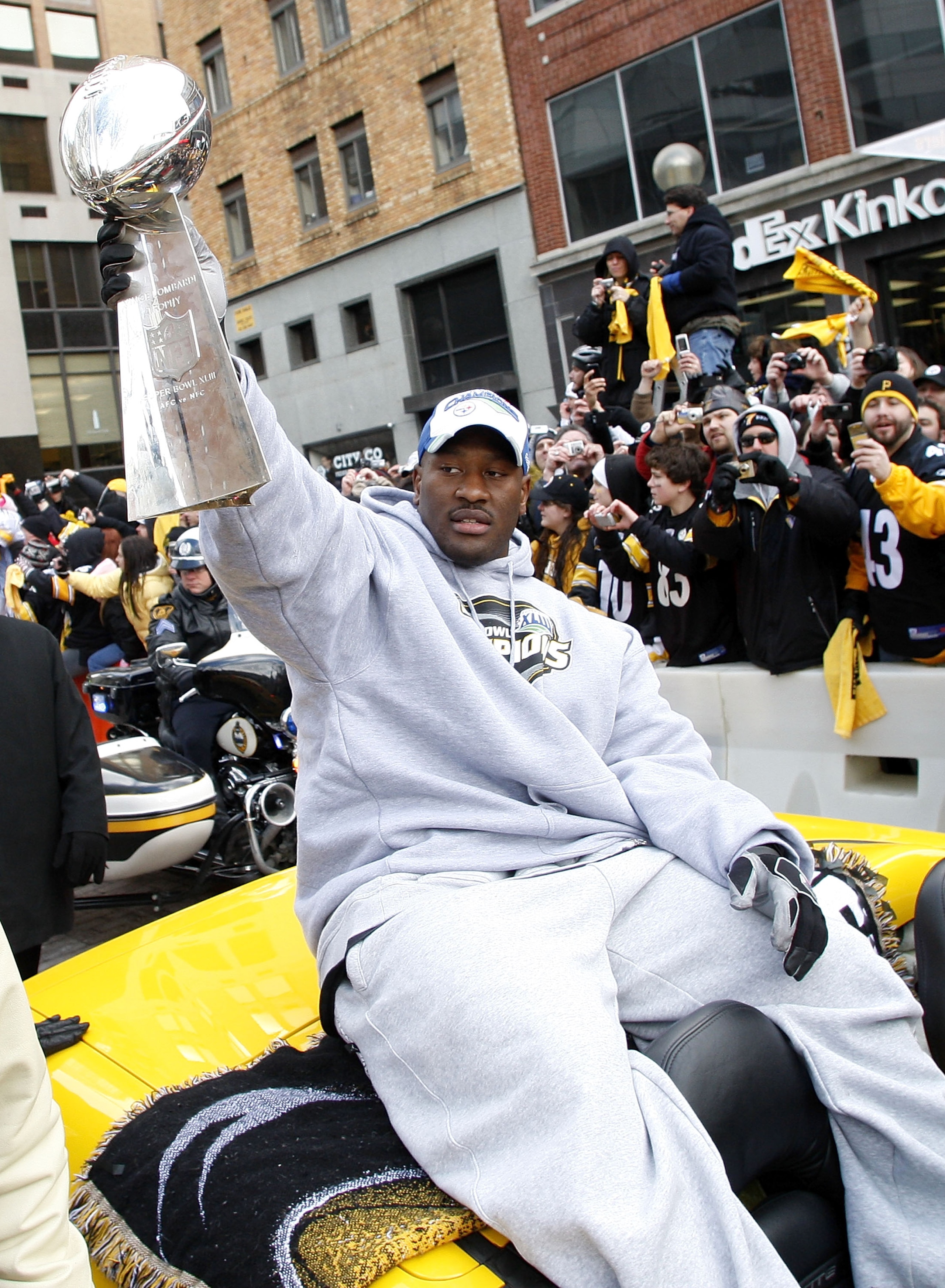 PITTSBURGH - FEBRUARY 03:  James Harrison #92 of the Pittsburgh Steelers shows off the Super Bowl XLIII trophy during a parade on February 3, 2009 in Pittsburgh, Pennsylvania.  (Photo by Gregory Shamus/Getty Images)