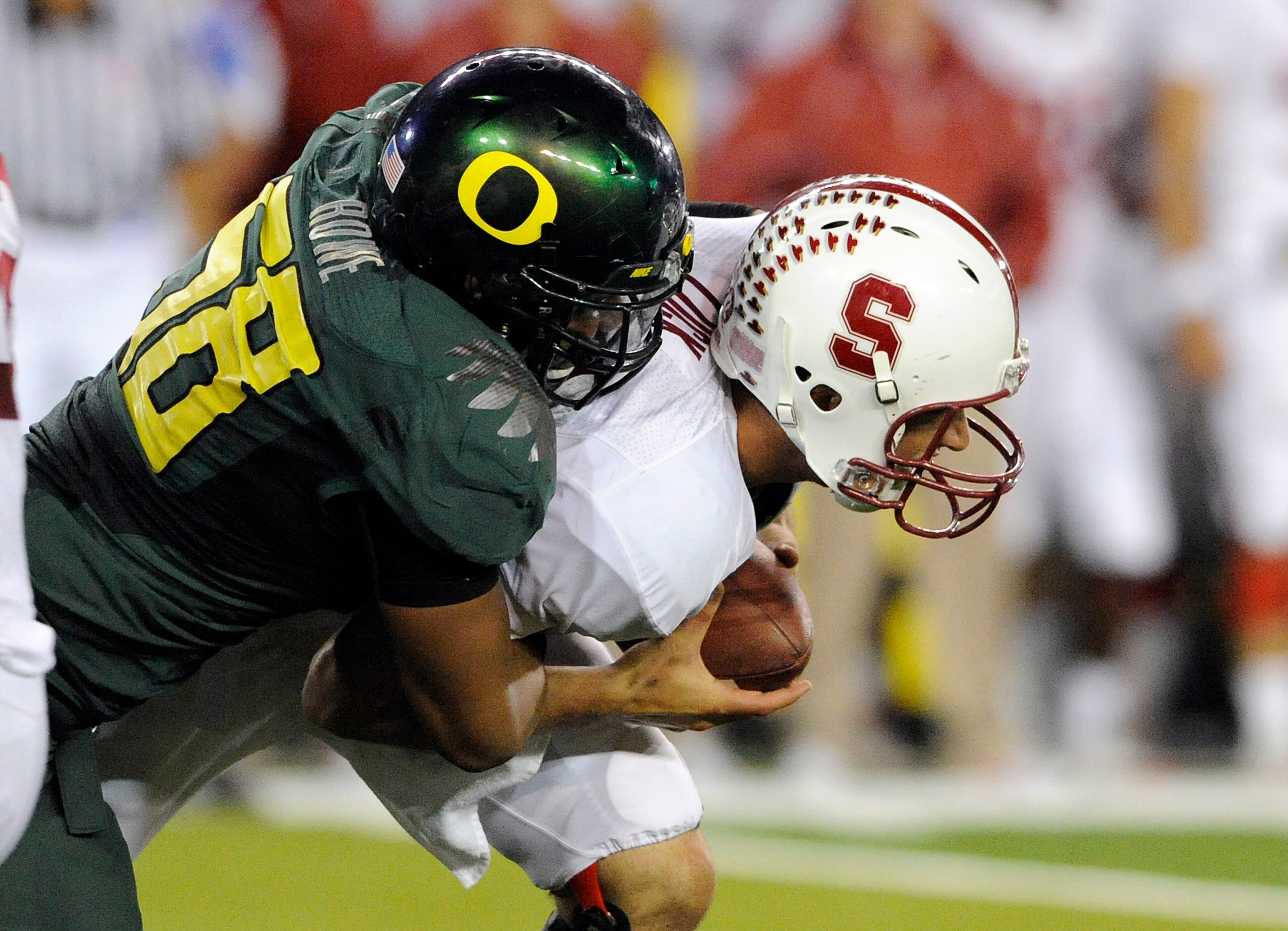 EUGENE, OR - OCTOBER 2: Quarterback Andrew Luck #12 of the Stanford Cardinal is sacked by defensive end Kenny Rowe #58 of the Oregon Ducks in the third quarter of the game at Autzen Stadium on October 2, 2010 in Eugene, Oregon. Oregon won the game 52-31.