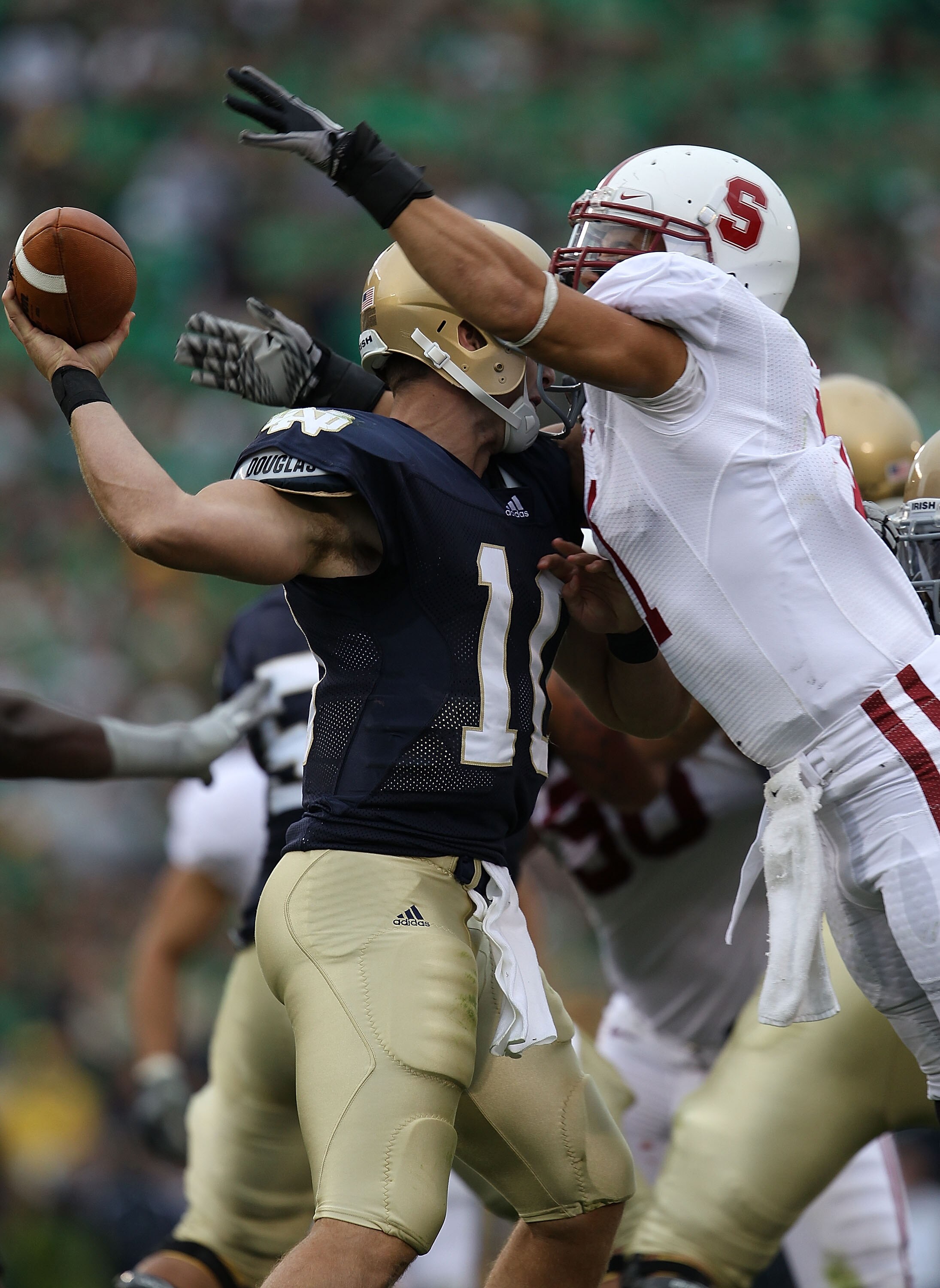 SOUTH BEND, IN - SEPTEMBER 25: Shayne Skov #11 of the Stanford Cardinal hits Dayne Crist #10 of the Notre Dame Fighting Irish forcing Crist to fumble at Notre Dame Stadium on September 25, 2010 in South Bend, Indiana.  (Photo by Jonathan Daniel/Getty Imag