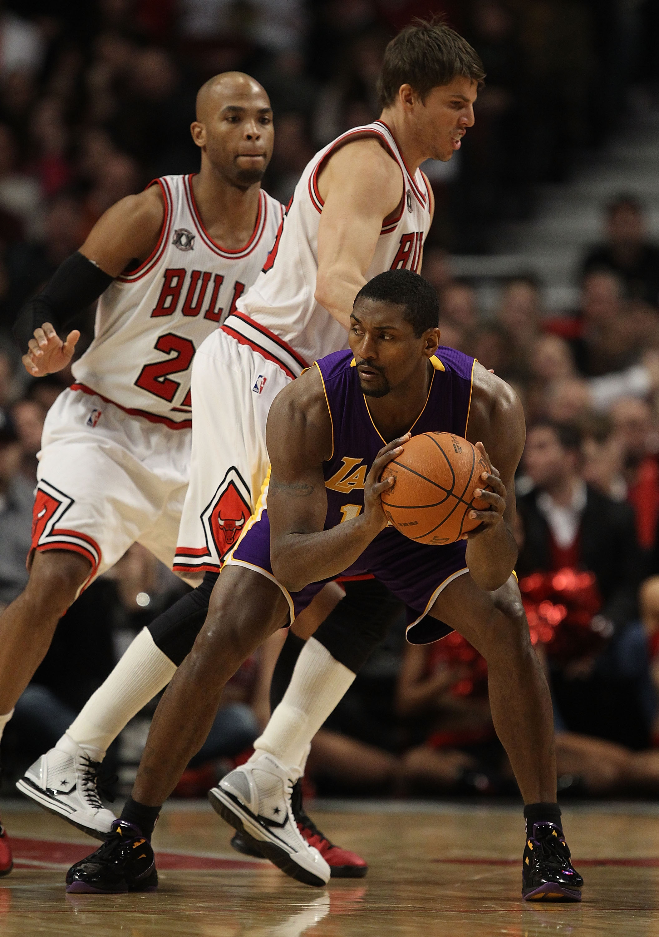 CHICAGO, IL - DECEMBER 10: Ron Artest #15 of the Los Angeles Lakers looks to pass as Kyle Korver #26 and Taj Gibson #22 of the Chicago Bulls defend at the United Center on December 10, 2010 in Chicago, Illinois. The Bulls defeated the Lakers 88-84. NOTE T