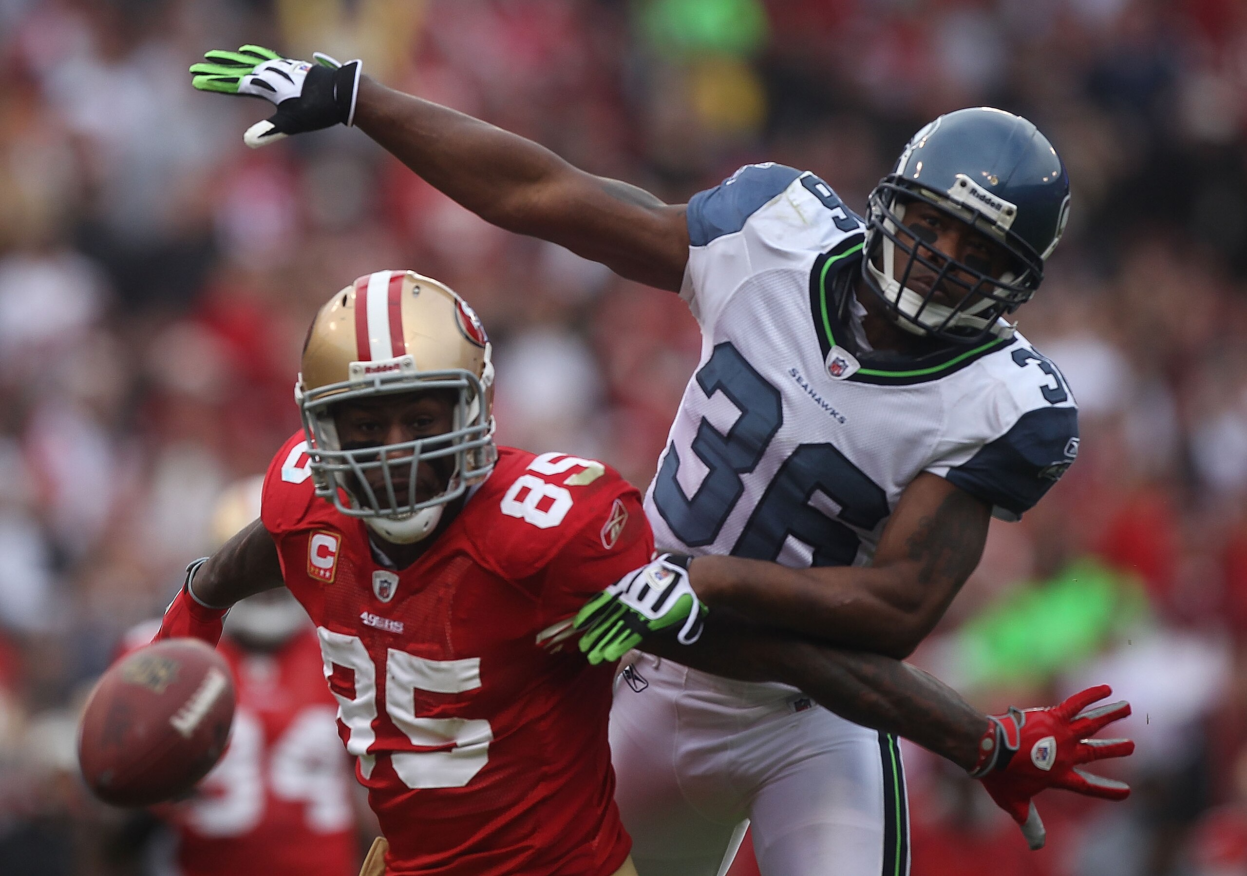 SAN FRANCISCO - DECEMBER 12:  Vernon Davis #85 of the San Francisco 49ers can't reach a pass as Lawyer Milloy #36 of the Seattle Seahawks defends during an NFL game at Candlestick Park on December 12, 2010 in San Francisco, California.(Photo by Jed Jacobs