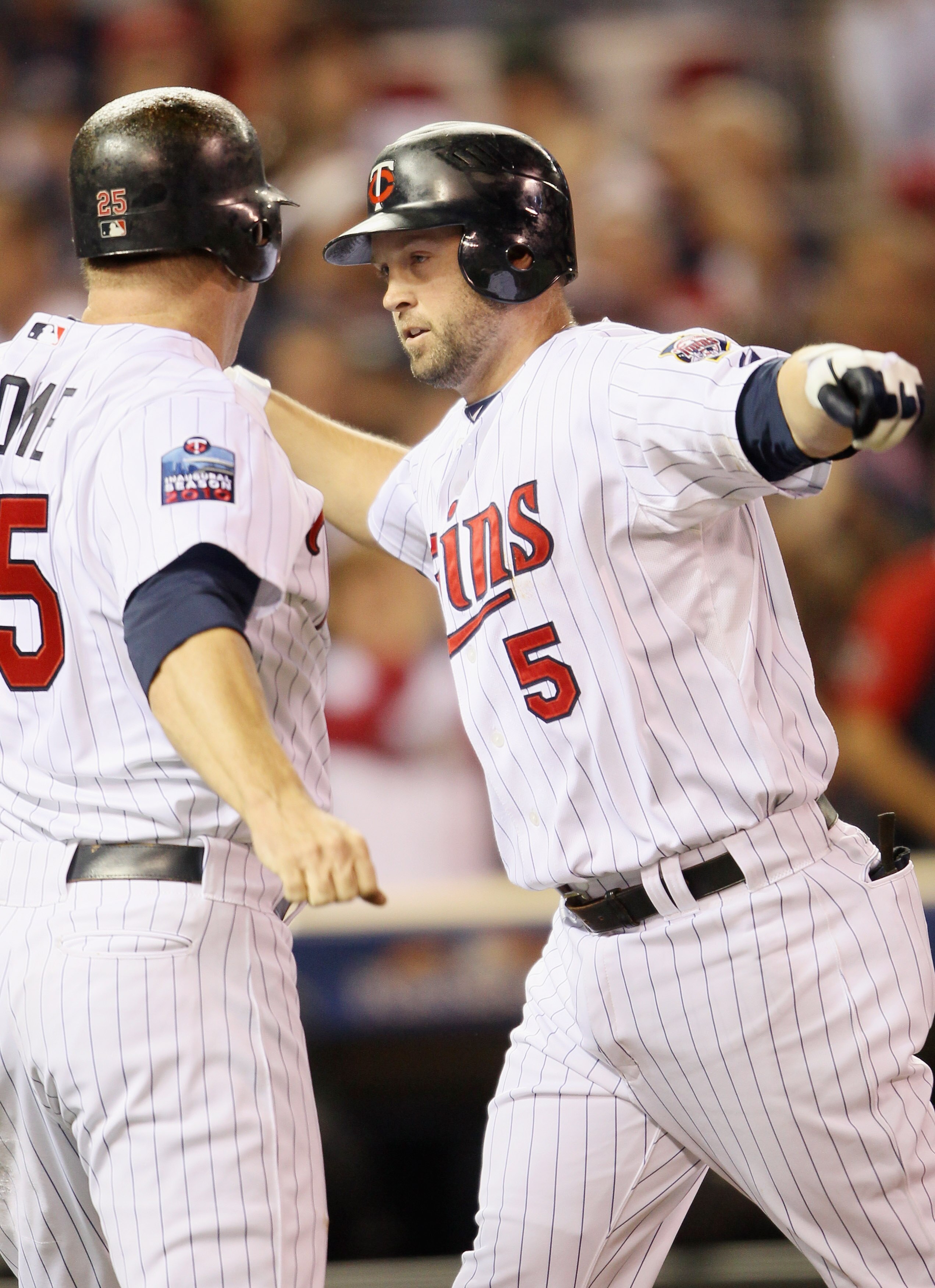 MINNEAPOLIS - OCTOBER 06:  Michael Cuddyer #5 of the Minnesota Twins celebrates his two run homer with teammate Jim Thome #25 in the second inning agianst the New York Yankees during game one of the ALDS on October 6, 2010 at Target Field in Minneapolis,