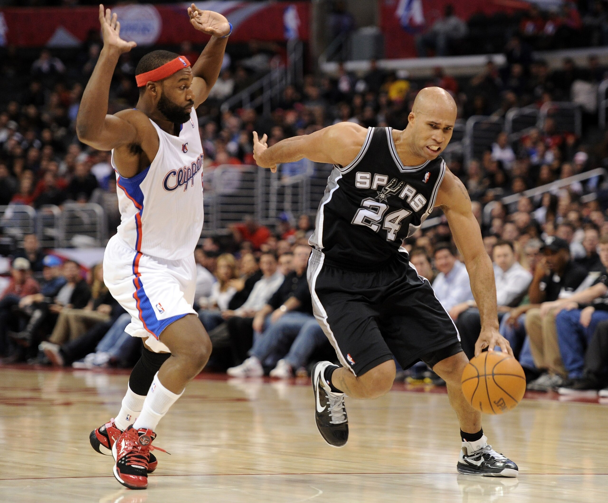 LOS ANGELES, CA - DECEMBER 01:  Richard Jefferson #24 of the San Antonio Spurs dribbles around Baron Davis #5 of the Los Angeles Clippers at the Staples Center on December 1, 2010 in Los Angeles, California.  NOTE TO USER: User expressly acknowledges and