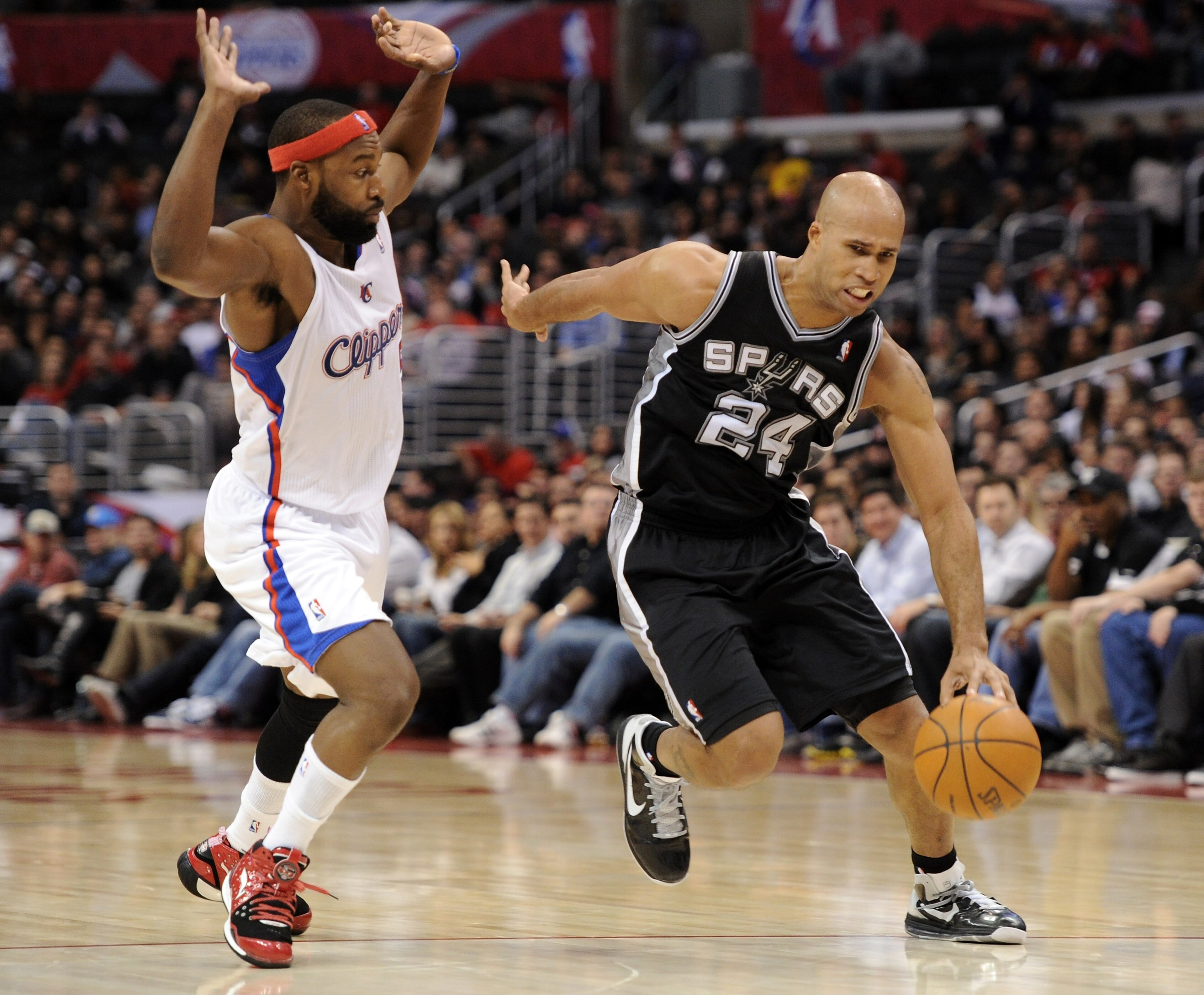 LOS ANGELES, CA - DECEMBER 01:  Richard Jefferson #24 of the San Antonio Spurs dribbles around Baron Davis #5 of the Los Angeles Clippers at the Staples Center on December 1, 2010 in Los Angeles, California.  NOTE TO USER: User expressly acknowledges and