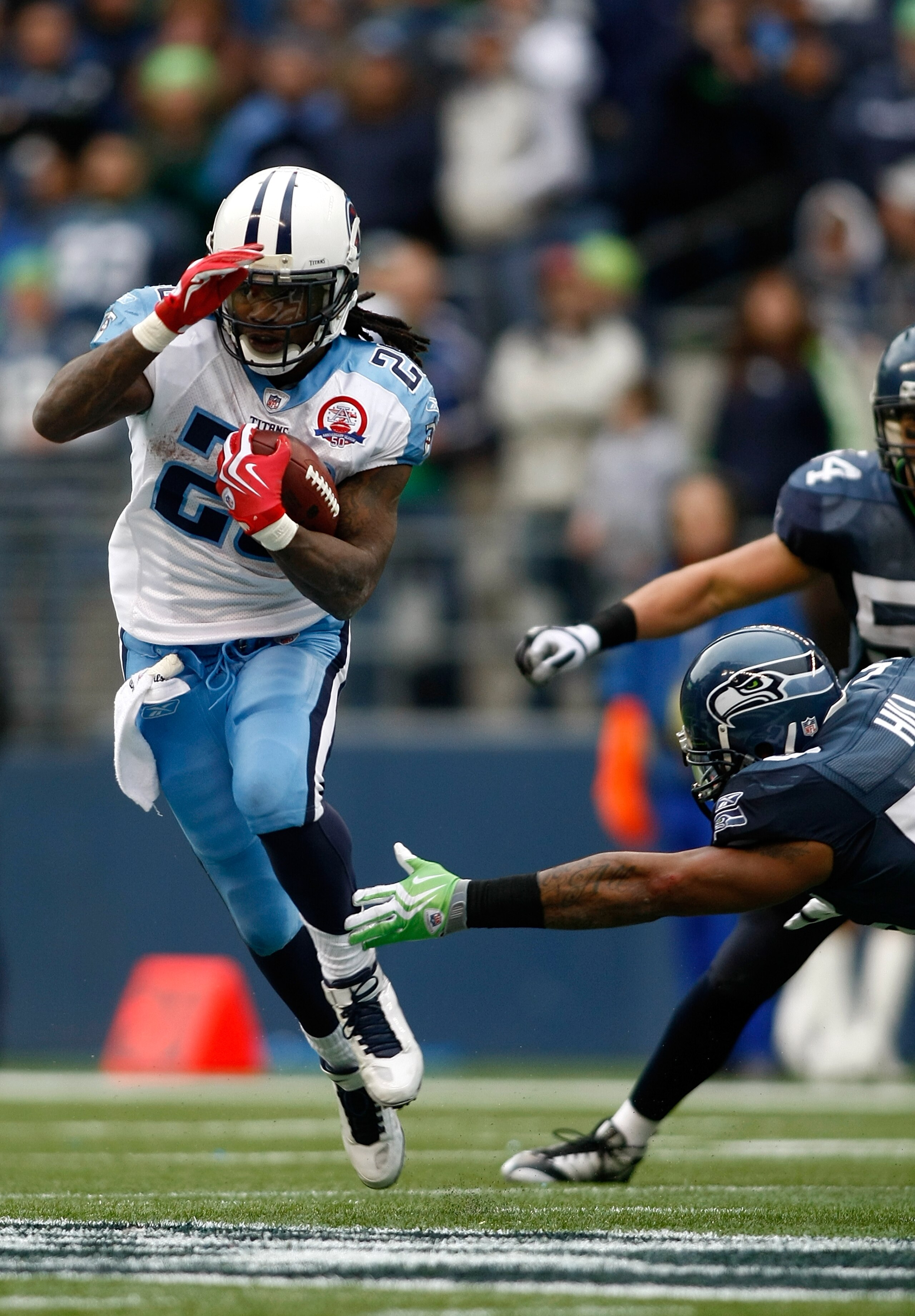 SEATTLE , WA - JANUARY 03:  Chris Johnson #28 of the Tennessee Titans runs with the ball against the Seattle Seahawks  17-13 at Qwest Field on January 3, 2010 in Seattle, Washington. Johnson ran for 134 yards to break the 2,000-yard mark for the season.
