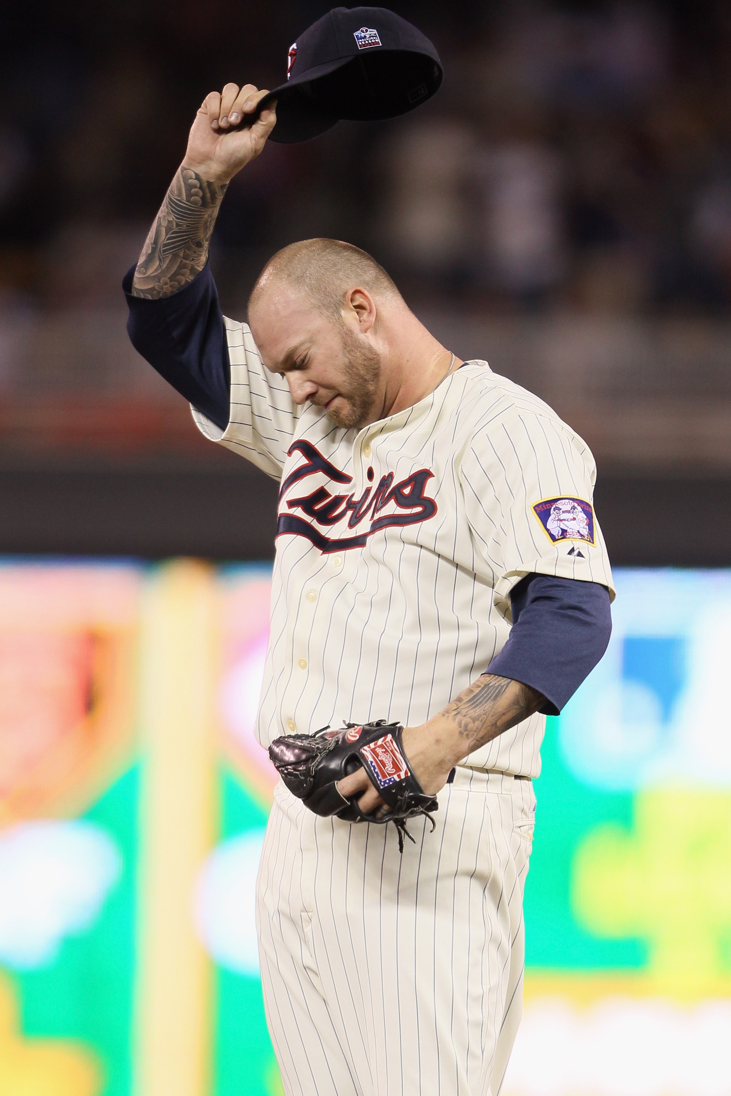 MINNEAPOLIS - OCTOBER 07:  Jon Rauch #60 of the Minnesota Twins wipes his brow against the New York Yankees during game two of the ALDS on October 7, 2010 at Target Field in Minneapolis, Minnesota.  (Photo by Elsa/Getty Images)