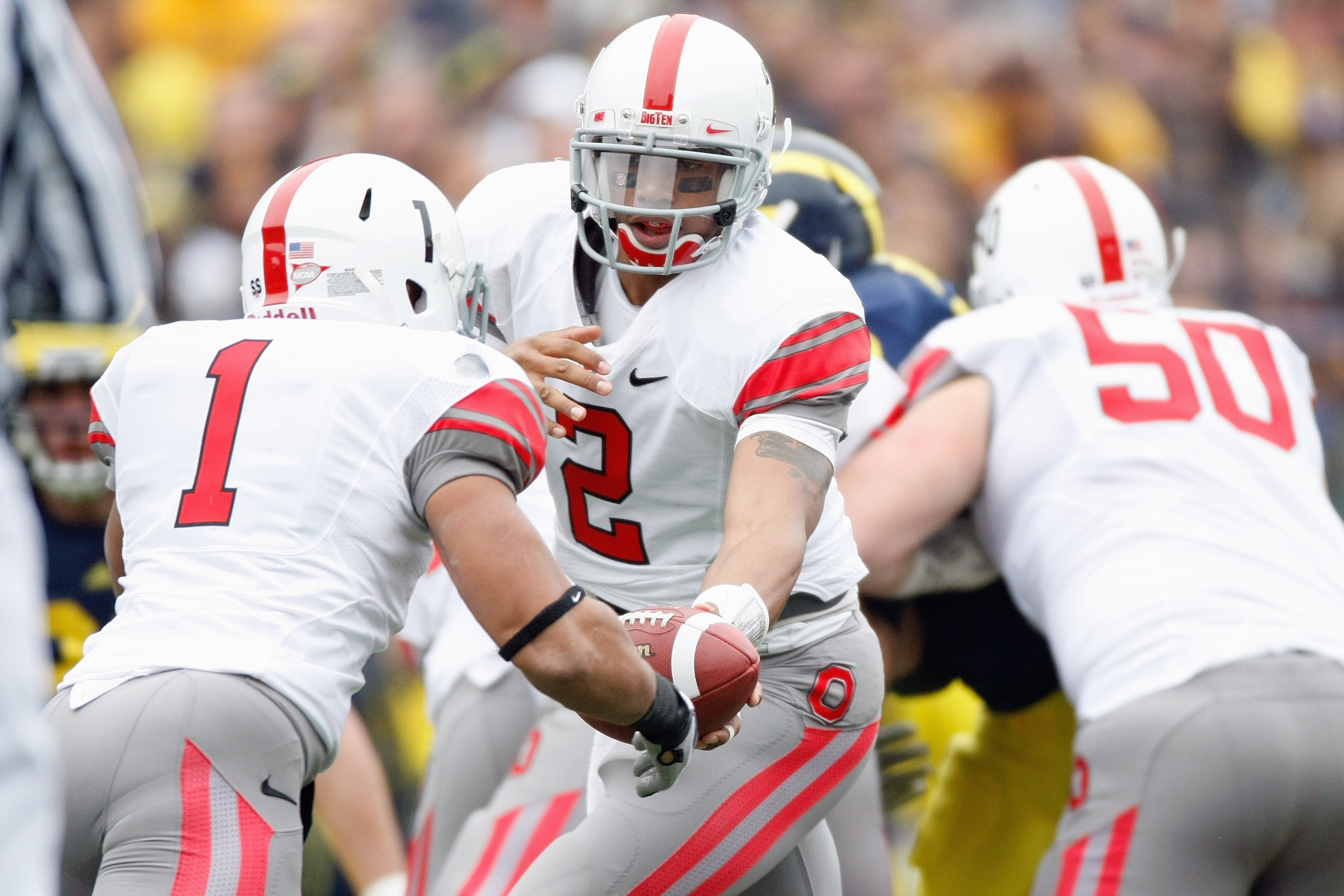 ANN ARBOR, MI - NOVEMBER 21:  Quarterback Terrelle Pryor #2 of the Ohio State Buckeyes hands the ball off to Dan Herron #1 during the game against the Michigan Wolverines on November 21, 2009 at Michigan Stadium in Ann Arbor, Michigan. Ohio State won the