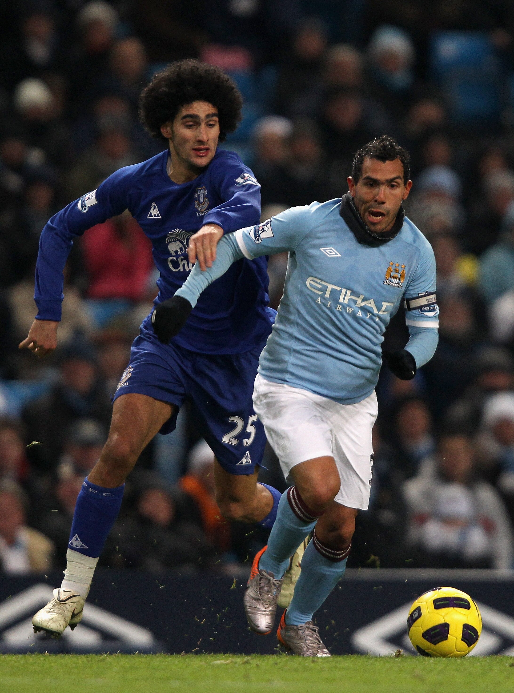 MANCHESTER, ENGLAND - DECEMBER 20:  Carlos Tevez of Manchester City in action with Marouane Fellaini of Everton during the Barclays Premier League match between Manchester City and Everton at City of Manchester Stadium on December 20, 2010 in Manchester,