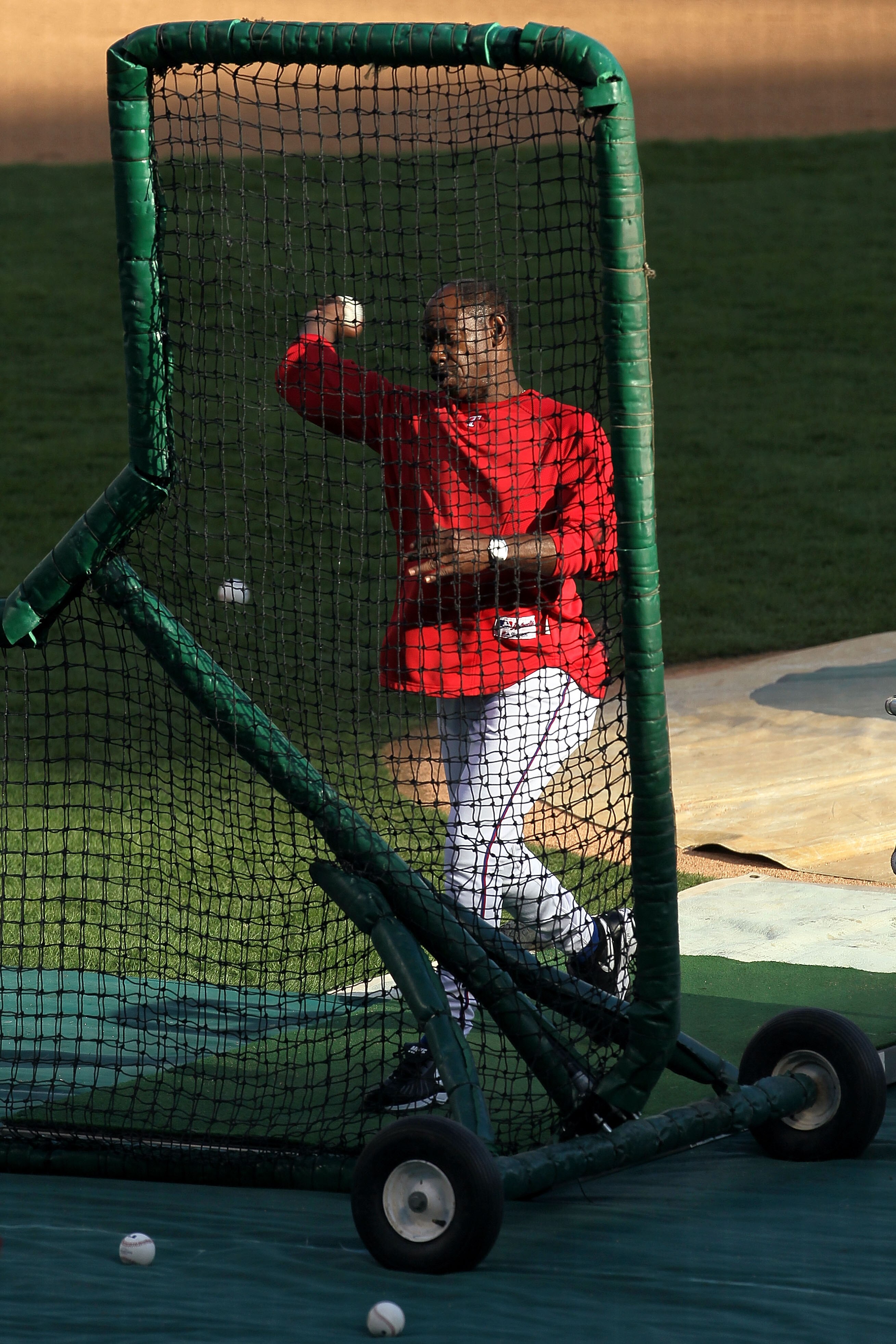 ARLINGTON, TX - NOVEMBER 01:  Manager Ron Washington of the Texas Rangers pitches batting practice to his players prior to playing against the San Francisco Giants in Game Five of the 2010 MLB World Series at Rangers Ballpark in Arlington on November 1, 2