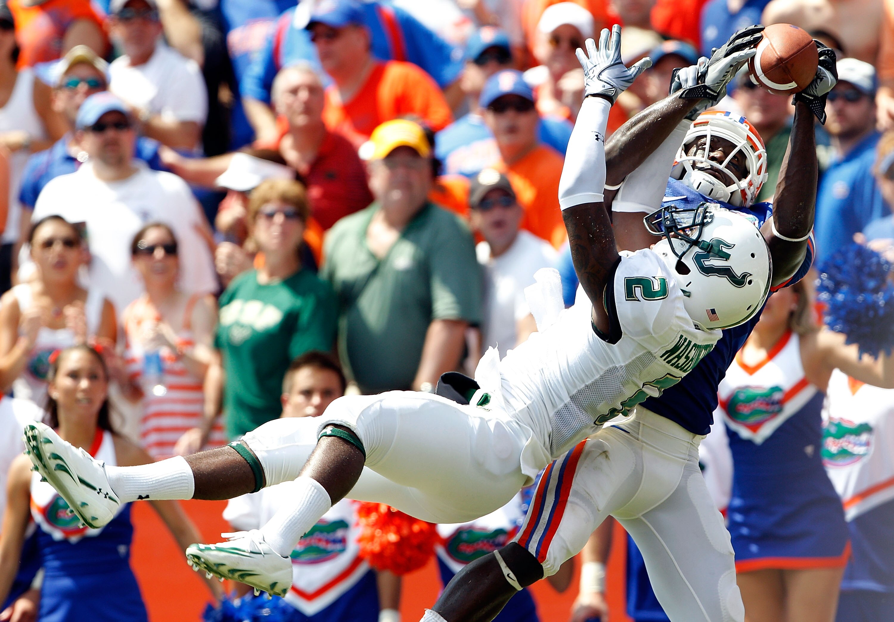 GAINESVILLE, FL - SEPTEMBER 11:  Deonte Thompson #6 of the Florida Gators attempts to make a catch over Quenton Washington #2 of the South Florida Bulls during a game at Ben Hill Griffin Stadium on September 11, 2010 in Gainesville, Florida.  (Photo by Sa