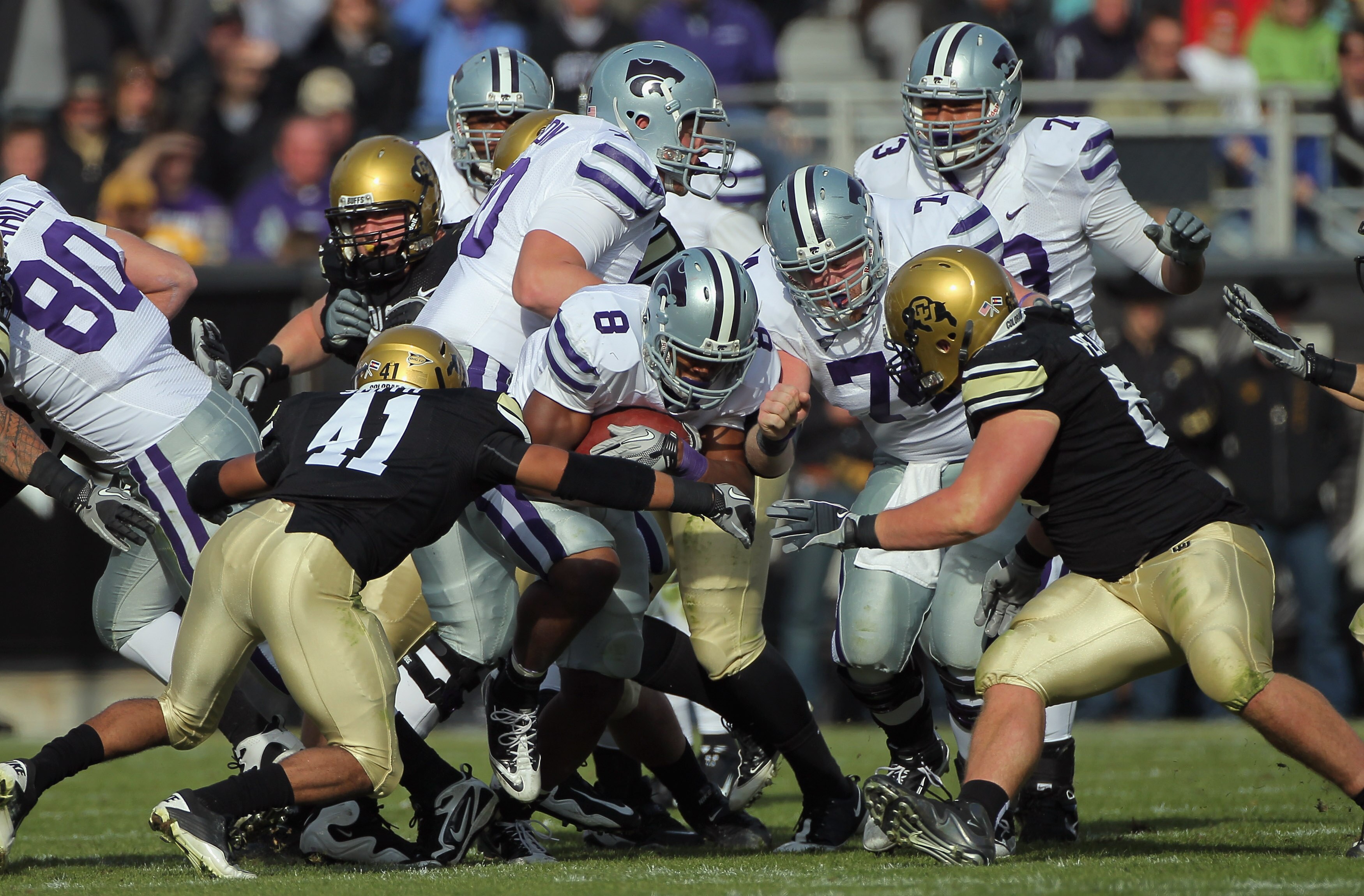 BOULDER, CO - NOVEMBER 20:  Daniel Thomas #8 of the Kansas State Wildcats rushes with the ball as Terrel Smith #41 and Will Pericak #83 of the Colorado Buffaloes close in for the tackle at Folsom Field on November 20, 2010 in Boulder, Colorado. Colorado d