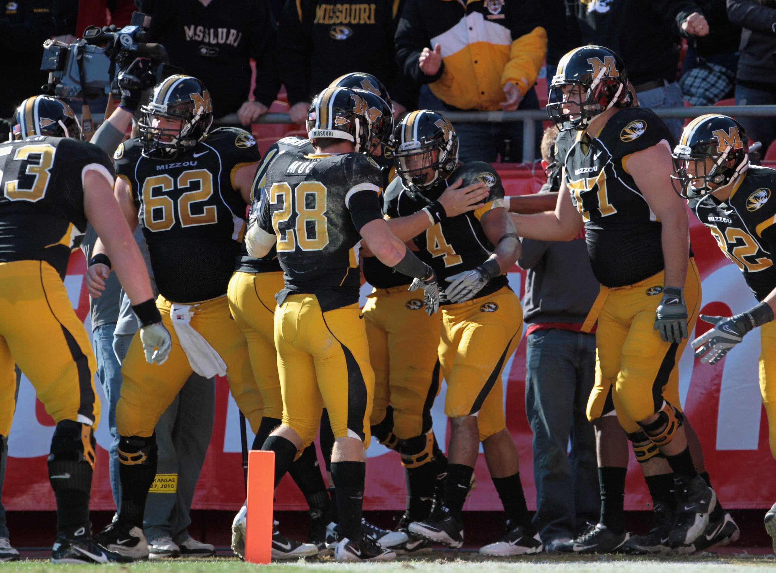 KANSAS CITY, MO - NOVEMBER 27:  Kendial Lawrence #4 of the Missouri Tigers is congratulated after scoring a touchdown during the game against the Kansas Jayhawks on November 27, 2010 at Arrowhead Stadium in Kansas City, Missouri.  (Photo by Jamie Squire/G