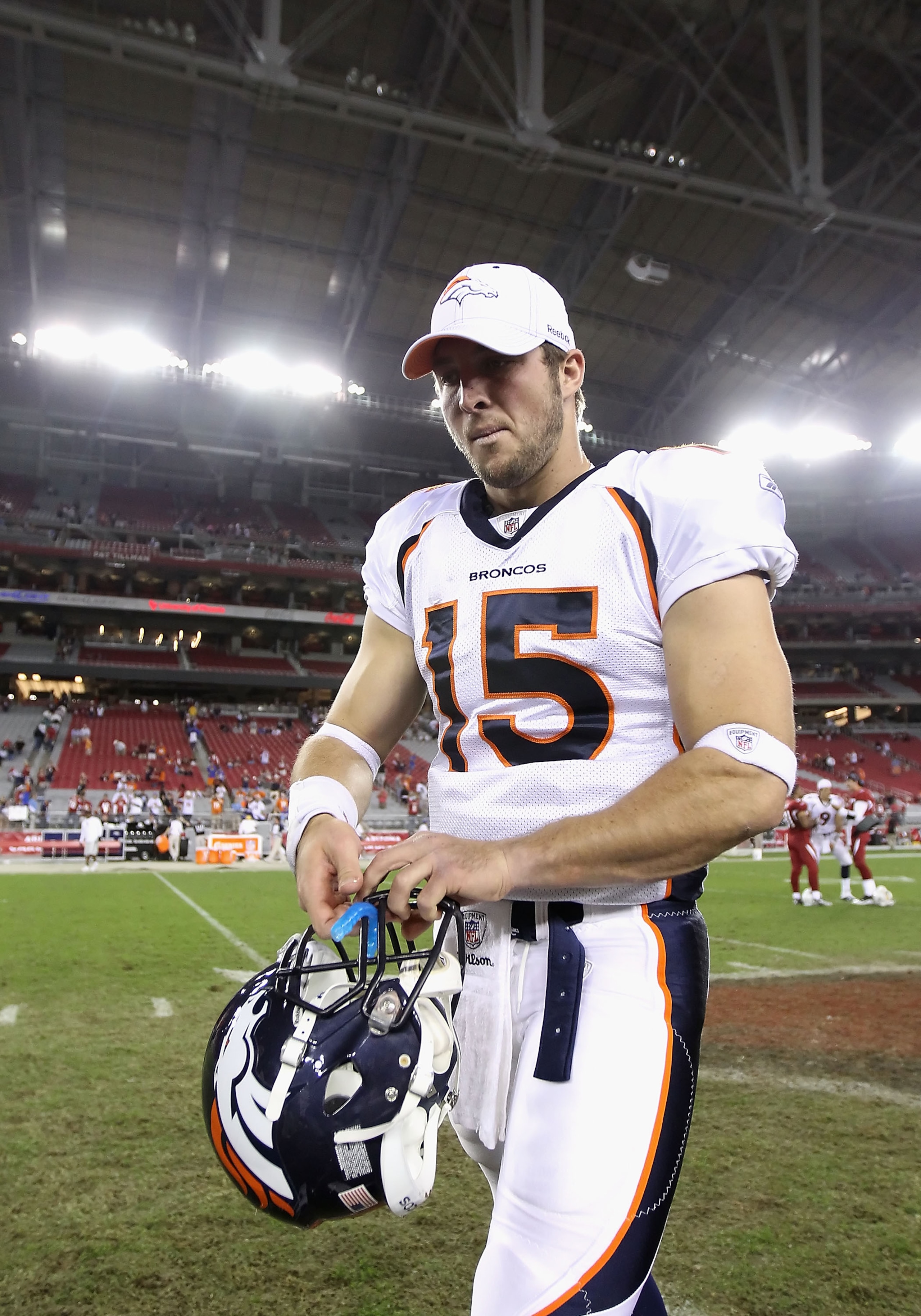 GLENDALE, AZ - DECEMBER 12:  Quarterback Tim Tebow #15 of the Denver Broncos walks off the field following the NFL game against the Arizona Cardinals at the University of Phoenix Stadium on December 12, 2010 in Glendale, Arizona.  The Cardinals defeated t