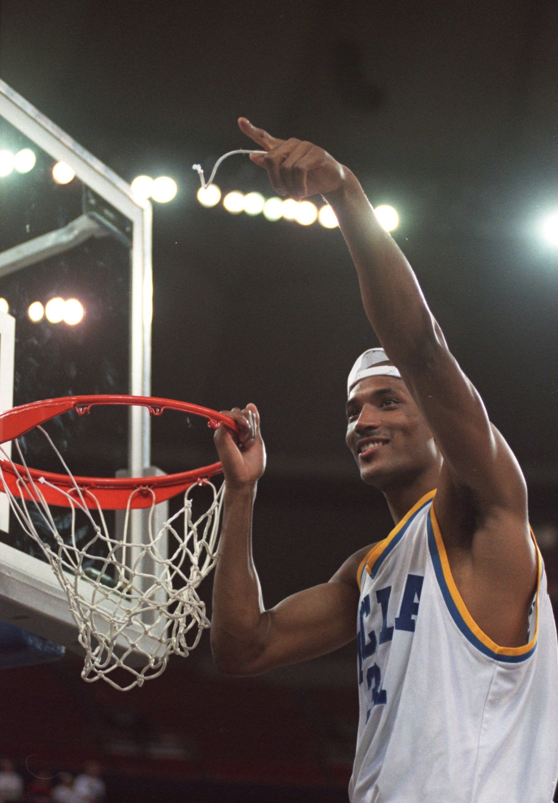 3 APR 1995:  UCLA FORWARD ED O''BANNON CELEBRATES THEIR 89-78 VICTORY OVER ARKANSAS IN THE NCAA FINAL AT THE KINGDOME IN SEATTLE, WASHINGTON AS HE CUTS DOWN THE NET.   Mandatory Credit: Stephen Dunn/ALLSPORT
