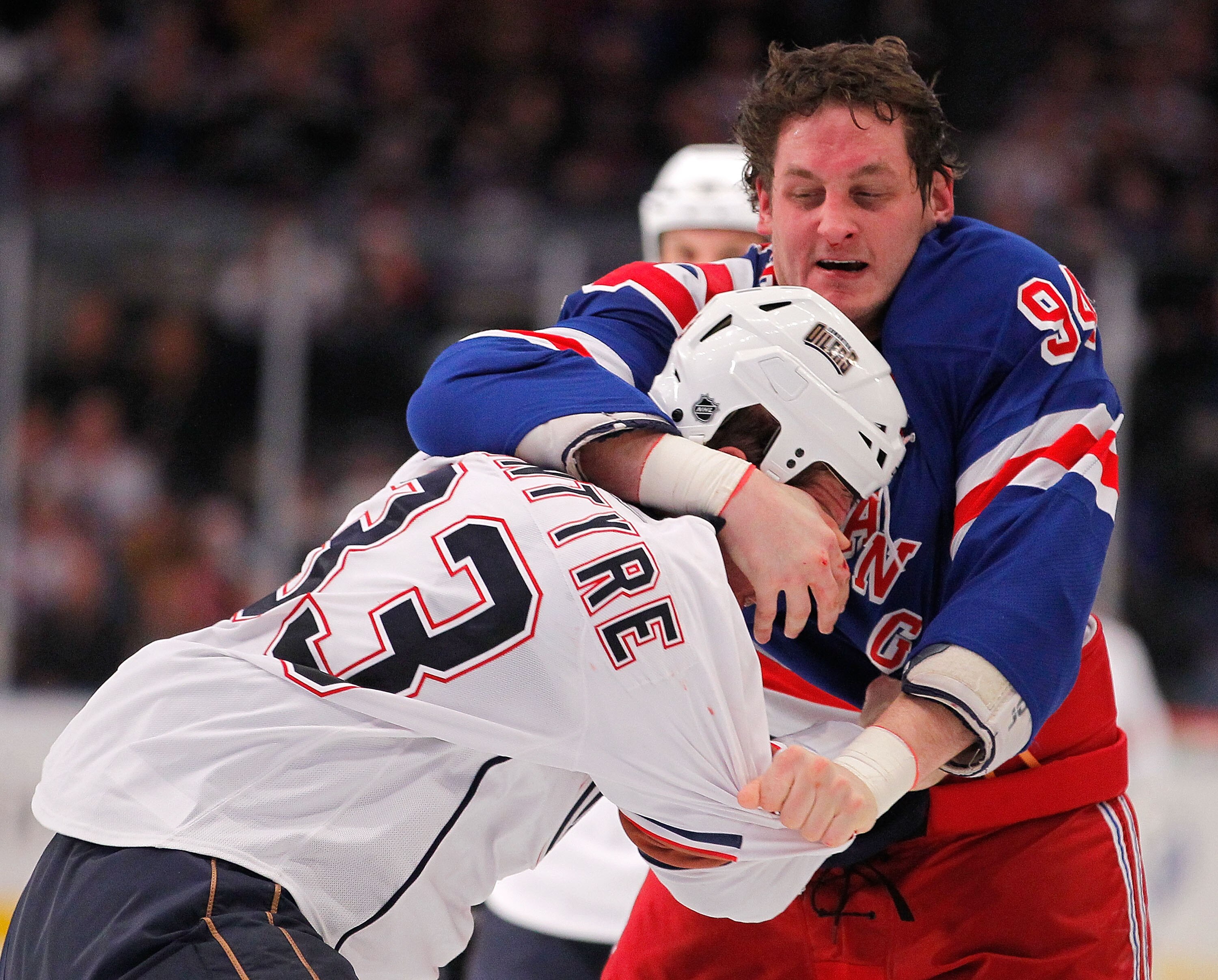 NEW YORK - NOVEMBER 14:  Steve MacIntyre #33 of the Edmonton Oilers fighting with Derek Boogaard #94 of the New York Rangers during a hockey game at Madison Square Garden on November 14, 2010 in New York City.  (Photo by Paul Bereswill/Getty Images)