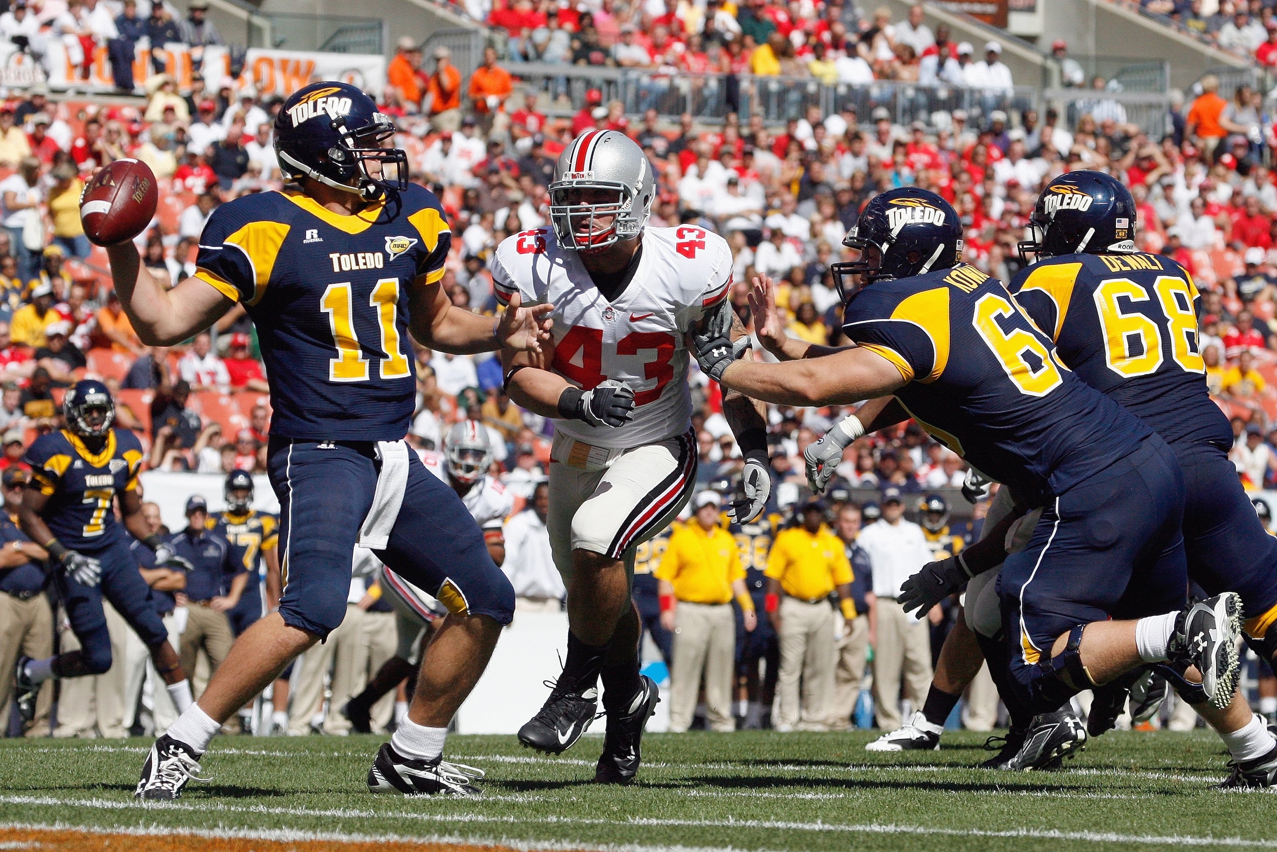 CLEVELAND - SEPTEMBER 19: Nathan Williams #43 of the Ohio State Buckeyes rushes quarterback Aaron Opelt #11 of the Toledo Rockets at Cleveland Browns Stadium on September 19, 2009 in Cleveland, Ohio. The Ohio State Buckeyes shutout the Toledo Rockets 38-0 CLEVELAND - SEPTEMBER 19: Nathan Williams #43 of the Ohio State Buckeyes rushes quarterback Aaron Opelt #11 of the Toledo Rockets at Cleveland Browns Stadium on September 19, 2009 in Cleveland, Ohio. The Ohio State Buckeyes shutout the Toledo Rockets 38-0