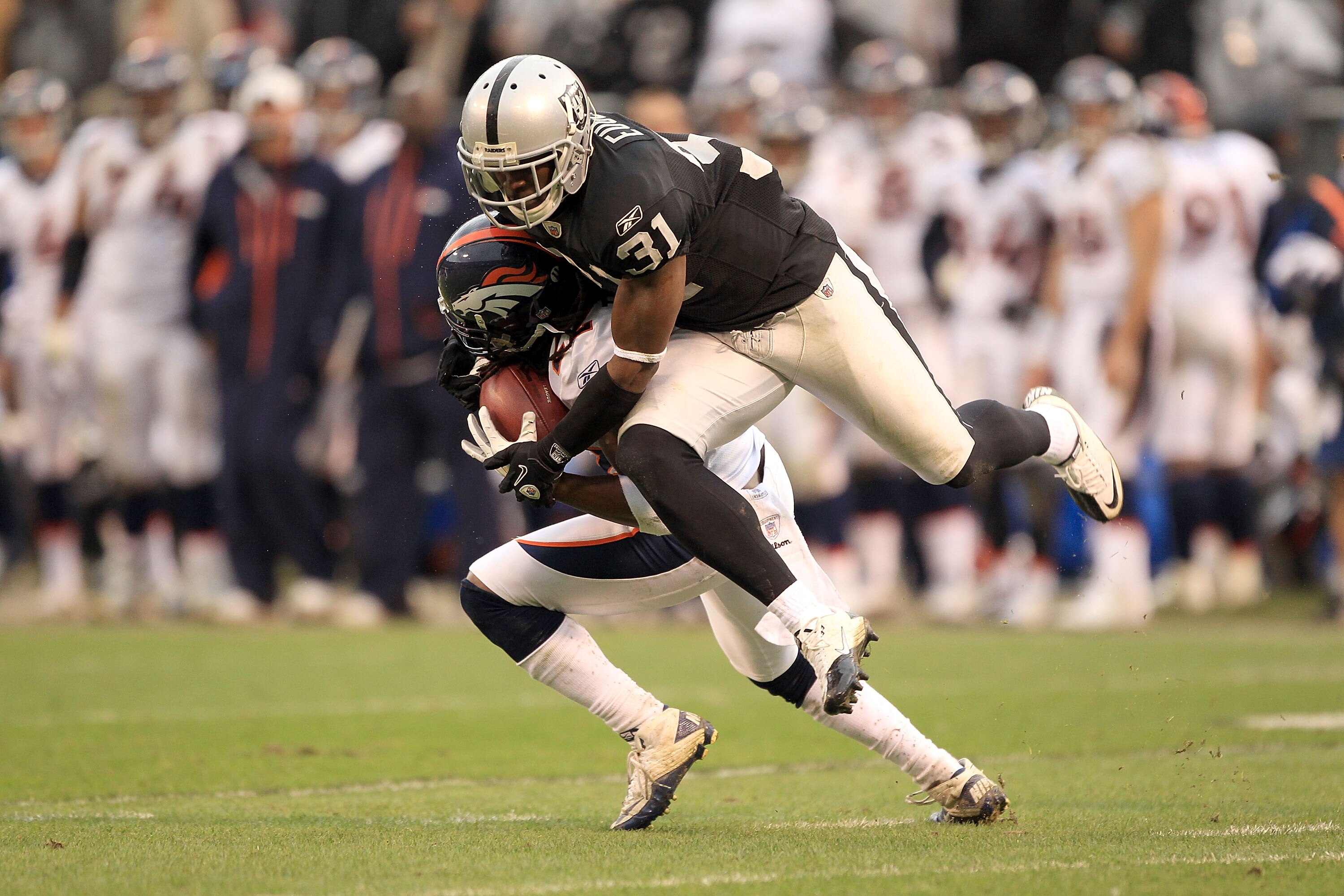OAKLAND, CA - DECEMBER 19:  Syd'Quan Thompson #22 of the Denver Broncos is tackled by Hiram Eugene #31 of the Oakland Raiders at Oakland-Alameda County Coliseum on December 19, 2010 in Oakland, California.  (Photo by Ezra Shaw/Getty Images)