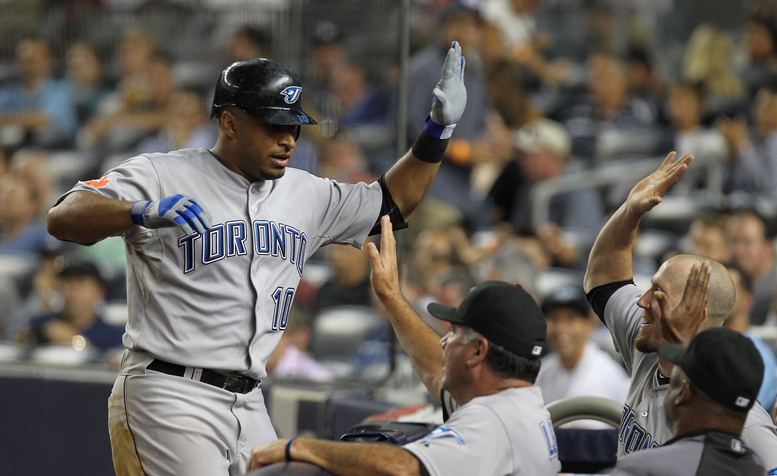 NEW YORK - AUGUST 03:  Vernon Wells #10 of the Toronto Blue Jays is congratulated by teammates on his eighth inning home run against the New York Yankees at Yankee Stadium on August 3, 2010 in the Bronx borough of New York City.  (Photo by Nick Laham/Gett