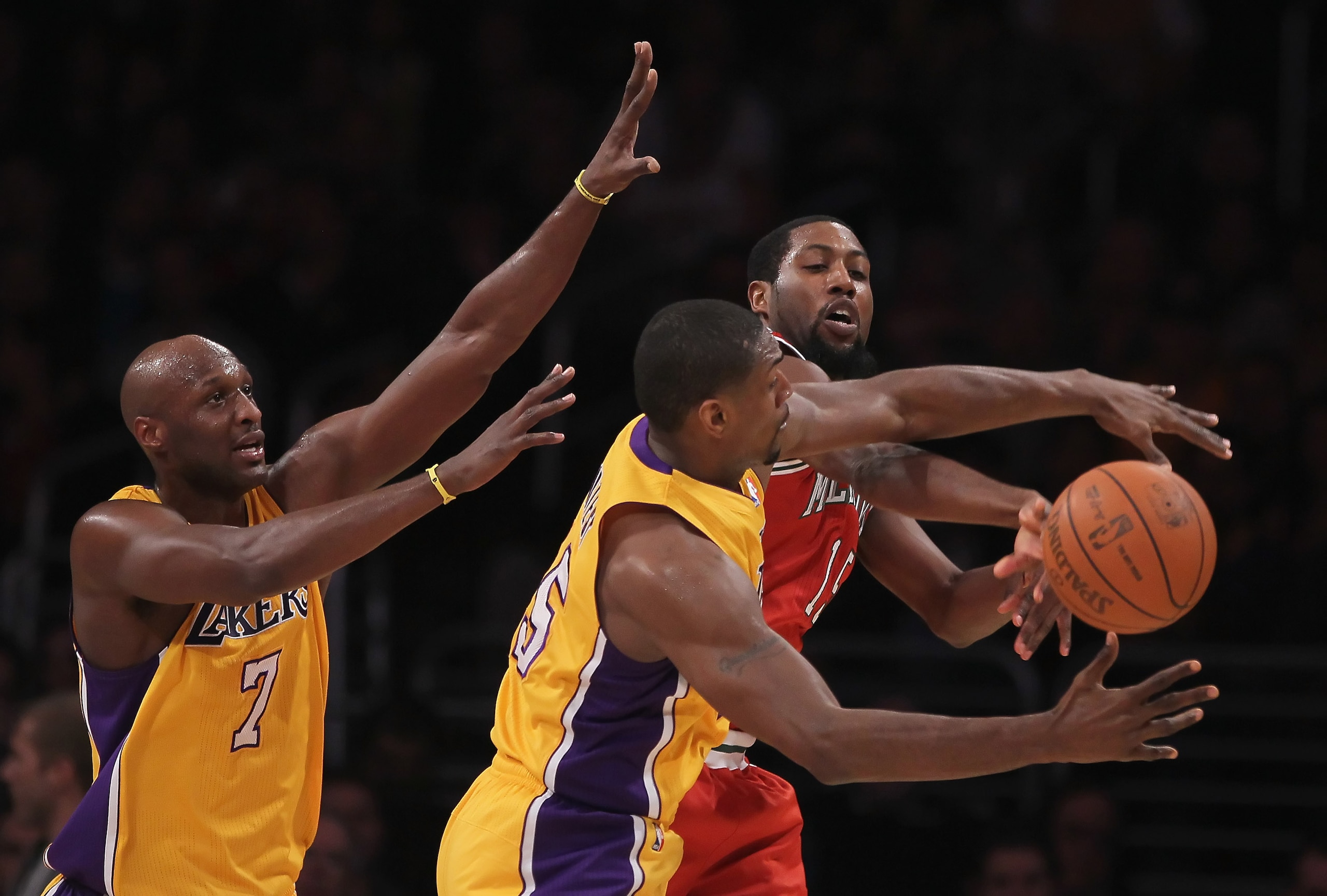 LOS ANGELES, CA - DECEMBER 21:  (L-R) Lamar Odom #7 and Ron Artest #15 of the Los Angeles Lakers defend John Salmons #15 of the Milwaukee Bucks during the first half at Staples Center on December 21, 2010 in Los Angeles, California. NOTE TO USER: User exp