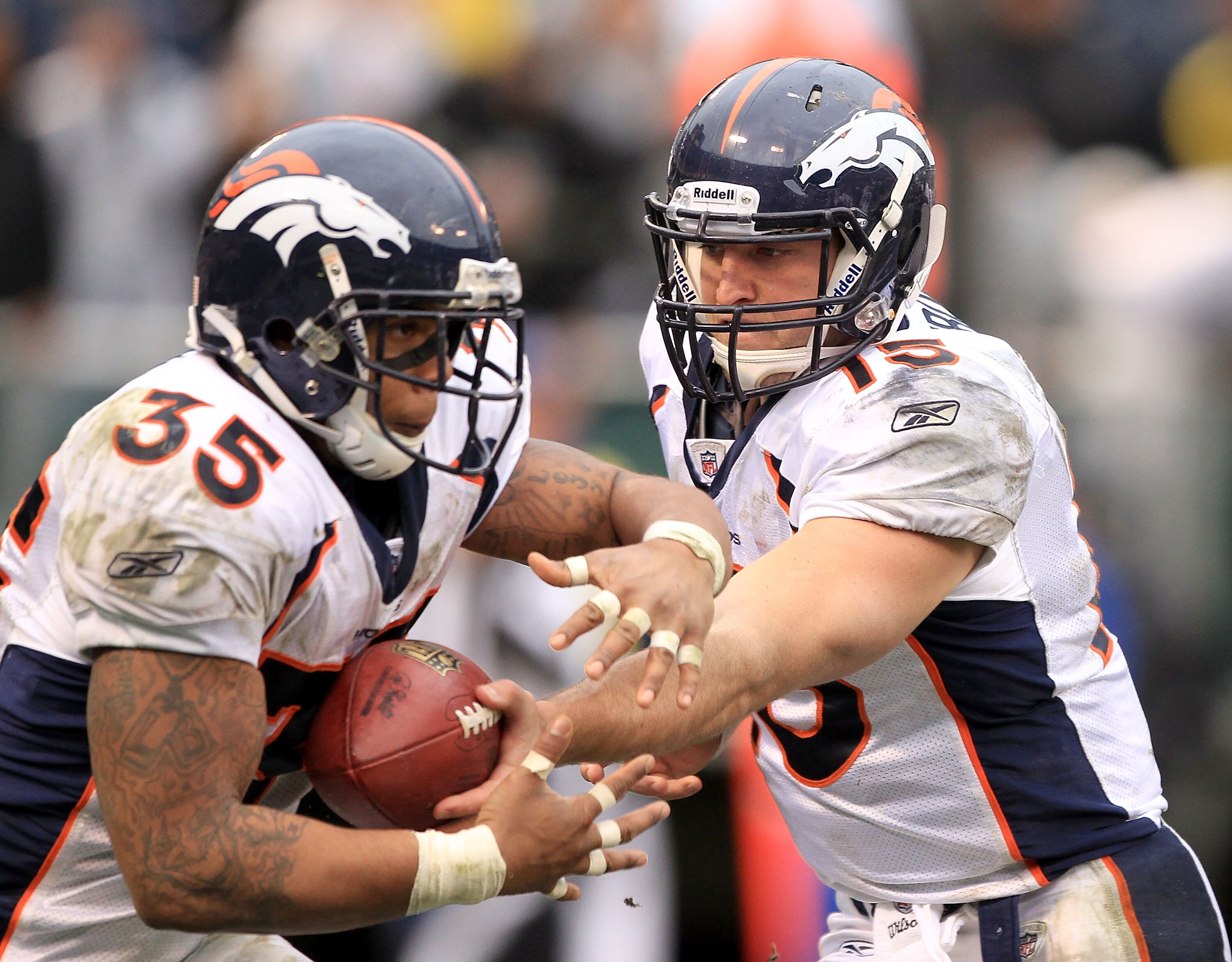 OAKLAND, CA - DECEMBER 19: Tim Tebow #15 of the Denver Broncos hands off to Lance Ball #35 during their game against the Oakland Raiders at Oakland-Alameda County Coliseum on December 19, 2010 in Oakland, California. (Photo by Ezra Shaw/Getty Images) OAKLAND, CA - DECEMBER 19: Tim Tebow #15 of the Denver Broncos hands off to Lance Ball #35 during their game against the Oakland Raiders at Oakland-Alameda County Coliseum on December 19, 2010 in Oakland, California. (Photo by Ezra Shaw/Getty Images)
