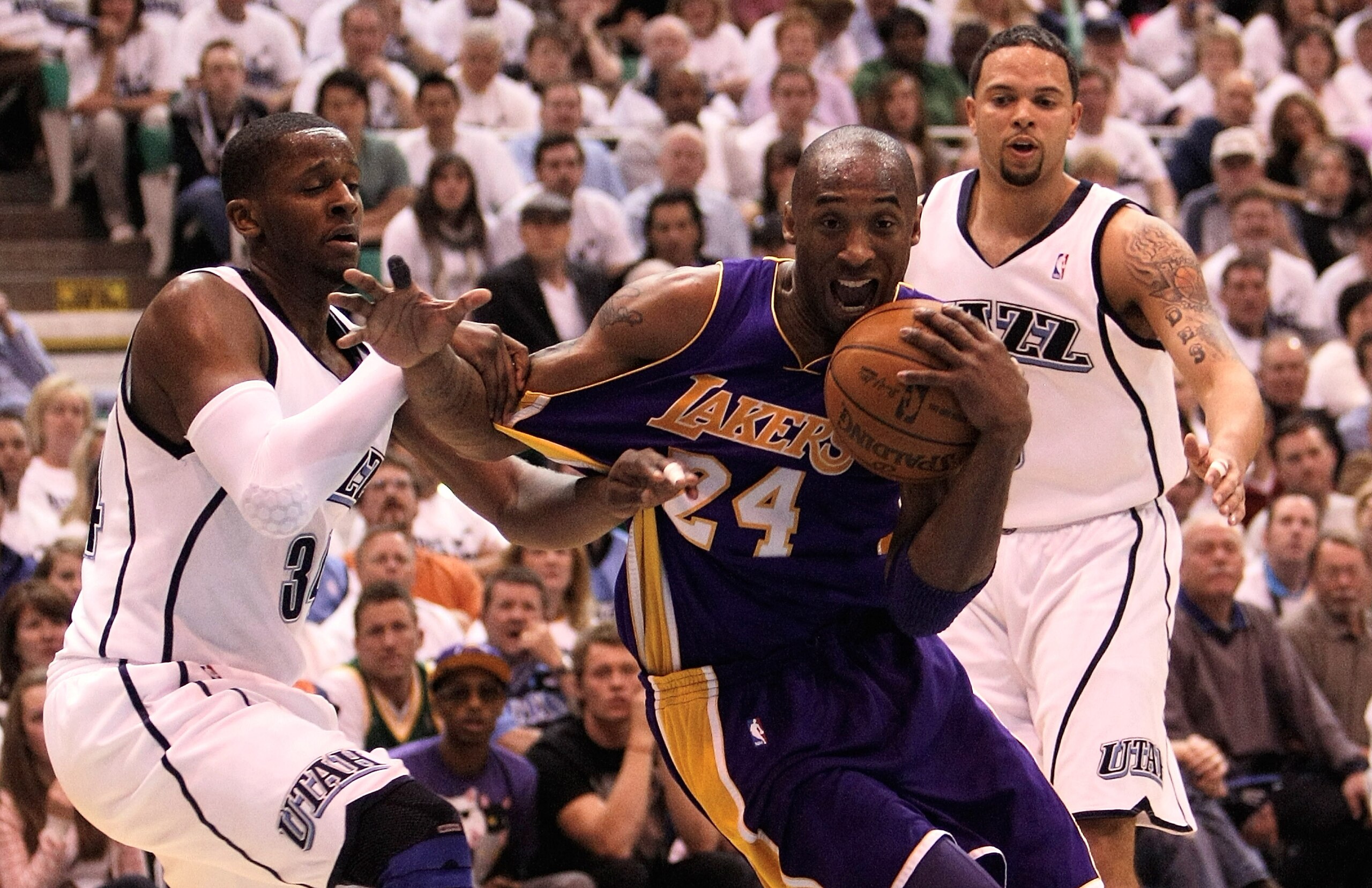 SALT LAKE CITY - MAY 08:  Kobe Bryant #24 of the Los Angeles Lakers is defended by  C.J. Miles #34  of the Utah Jazz during Game Three of the Western Conference Semifinals of the 2010 NBA Playoffs on May 8, 2010 at Energy Solutions Arena in Salt Lake City