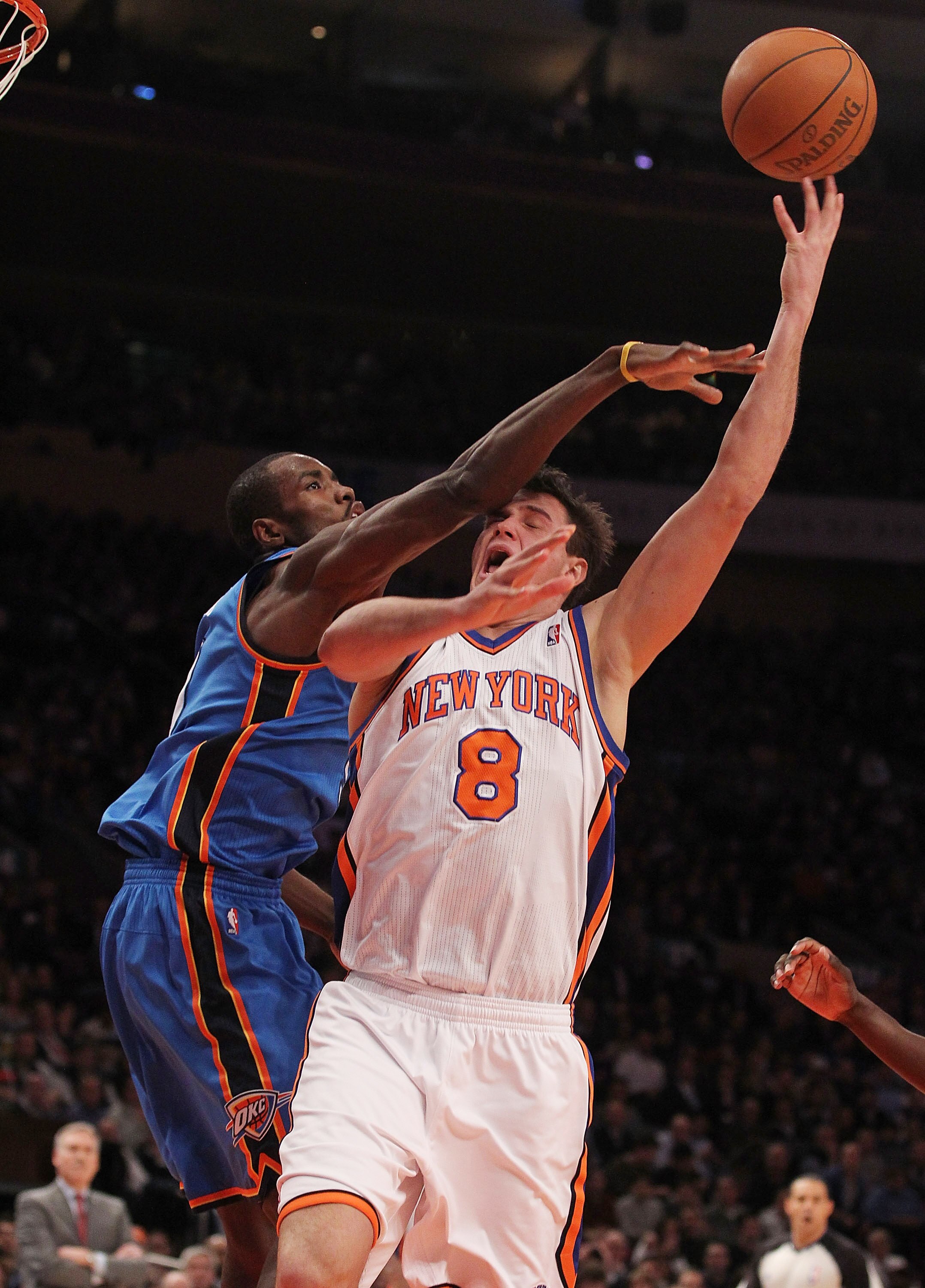 NEW YORK, NY - DECEMBER 22: Danilo Gallinari #8 of the New York Knicks is fouled by Serge Ibaka #9 of the Oklahoma City Thunder at Madison Square Garden on December 22, 2010 in New York City.   NOTE TO USER: User expressly acknowledges and agrees that, by