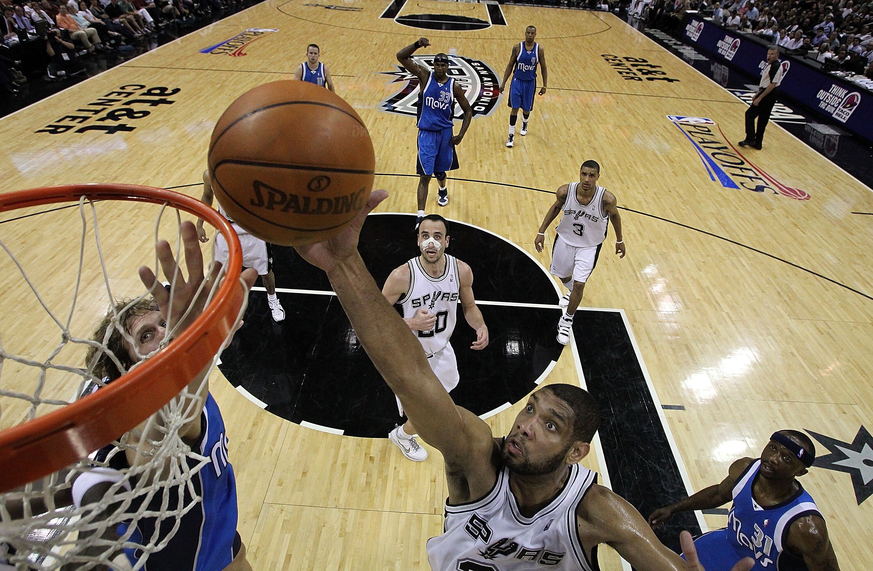 SAN ANTONIO - APRIL 25:  Forward Tim Duncan #21 of the San Antonio Spurs takes a shot against Dirk Nowitzki #41 of the Dallas Mavericks in Game Four of the Western Conference Quarterfinals during the 2010 NBA Playoffs at AT&T Center on April 25, 2010 in S