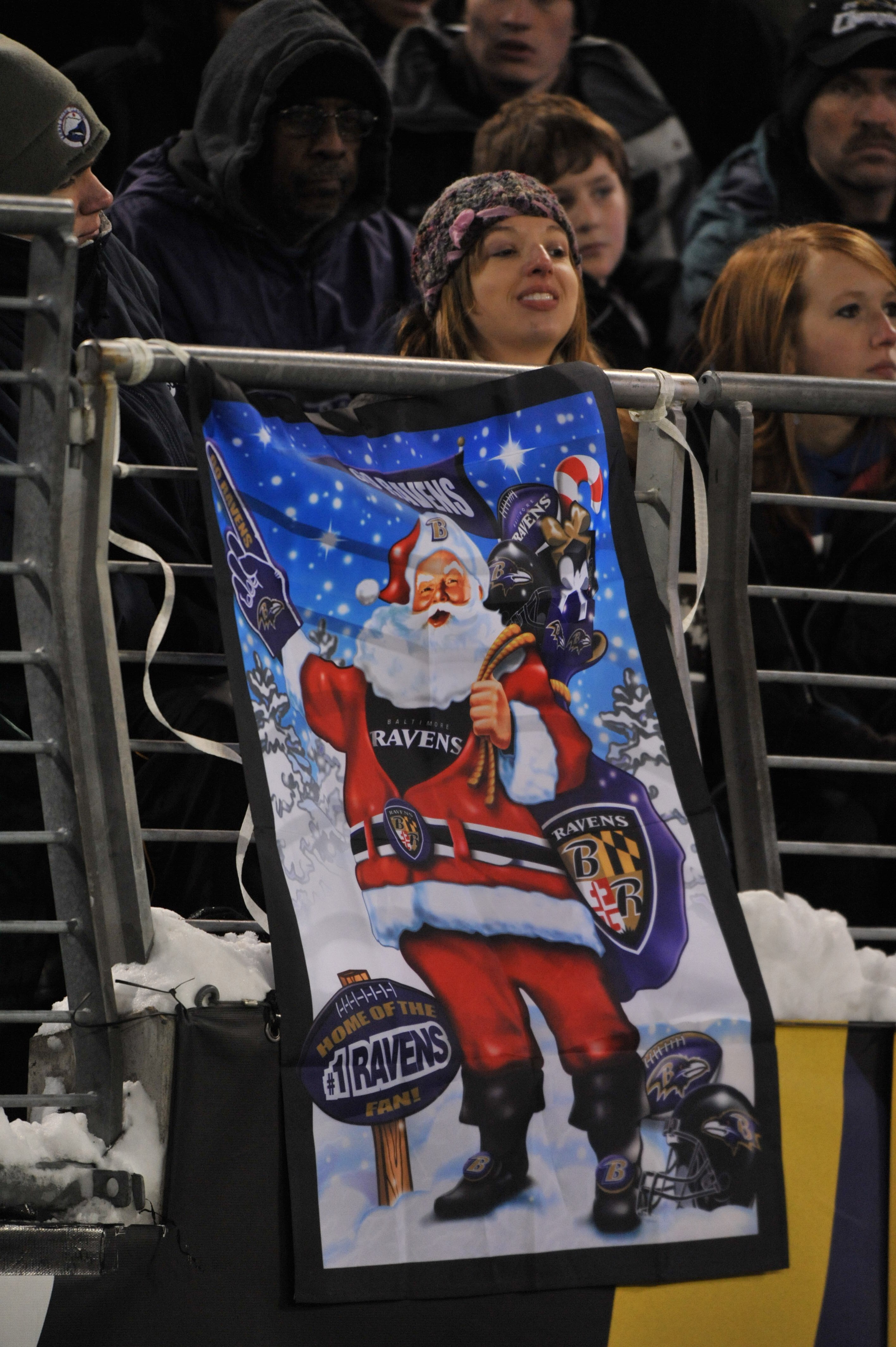 BALTIMORE - DECEMBER 20:  A female fan of the Baltimore Ravens celebrates Christmas with a Ravens banner during the game against the Chicago Bears at M&T Bank Stadium on December 20, 2009 in Baltimore, Maryland. The Ravens defeated the Bears 31-7. (Photo 
