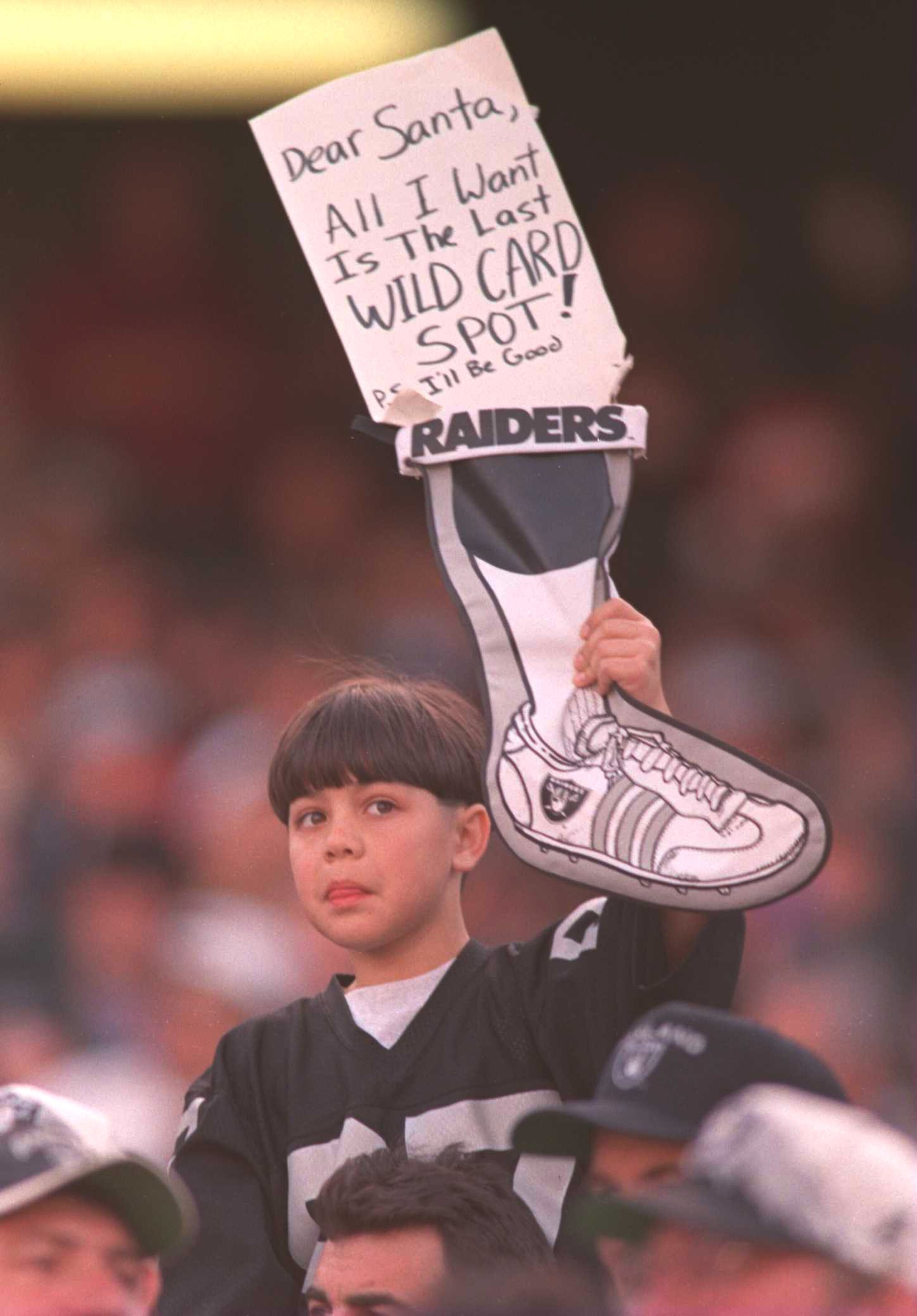 24 DEC 1995:  A RAIDER FAN ASKS FOR A CHRISTMAS GIFT DURING THE OAKLAND RAIDERS 34-28 LOSS TO THE DENVER BROCOS AT THE OAKLAND COLISEUM IN OAKLAND, CALIFORNIA.  THE RAIDERS WERE ELIMINATED FROM THE PLAYOFFS IN RESULT OF THE LOSS. Mandatory Credit: Jed Jac