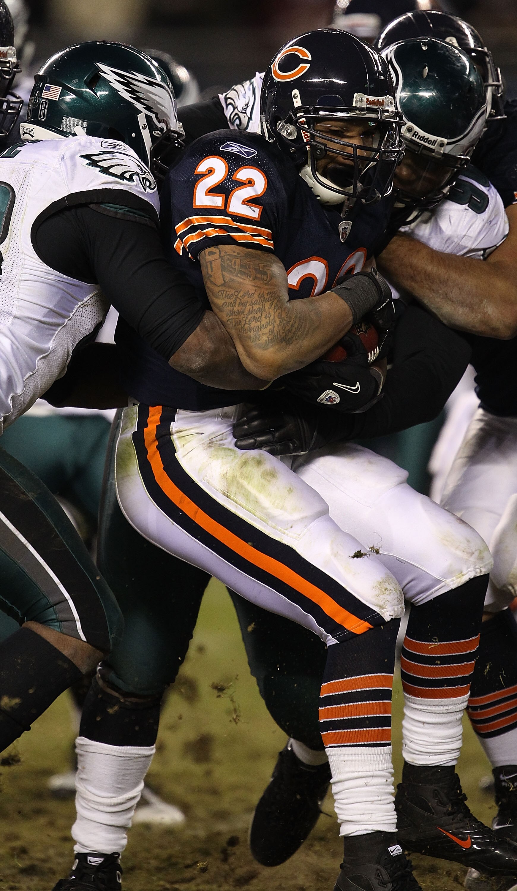 CHICAGO - NOVEMBER 28: Matt Forte #22 of the Chicago Bears is wrapped up by Trent Cole #58 and Antonio Dixon #90 of the Philadelphia Eagles at Soldier Field on November 28, 2010 in Chicago, Illinois. The Bears defeated the Eagles 31-26. (Photo by Jonathan