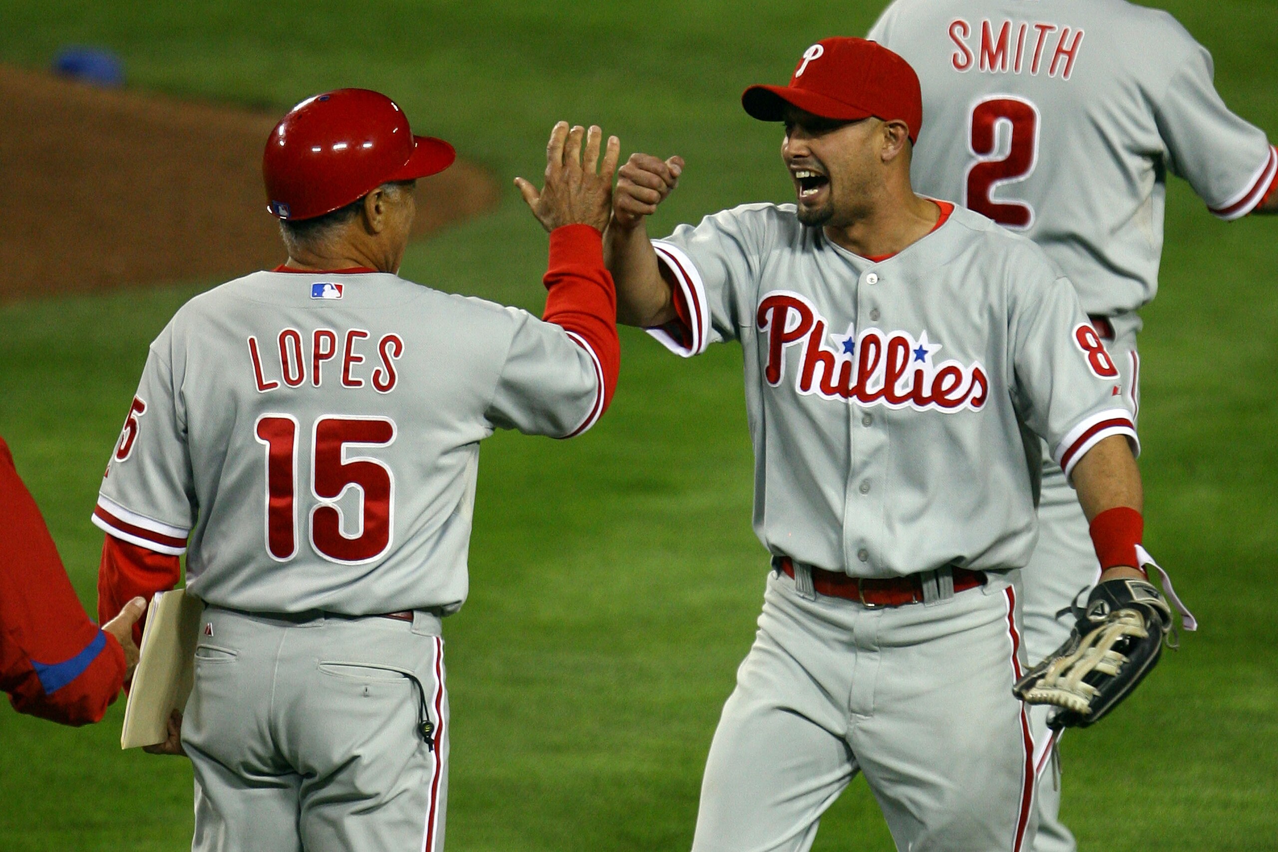 LOS ANGELES, CA - OCTOBER 13: (R) Shane Victorino #8 of the Philadelphia Phillies celebrates with coach Davey Lopes #15 after defeating the Los Angeles Dodgers 7-5 in Game Four of the National League Championship Series during the 2008 MLB playoffs on Oc LOS ANGELES, CA - OCTOBER 13: (R) Shane Victorino #8 of the Philadelphia Phillies celebrates with coach Davey Lopes #15 after defeating the Los Angeles Dodgers 7-5 in Game Four of the National League Championship Series during the 2008 MLB playoffs on Oc