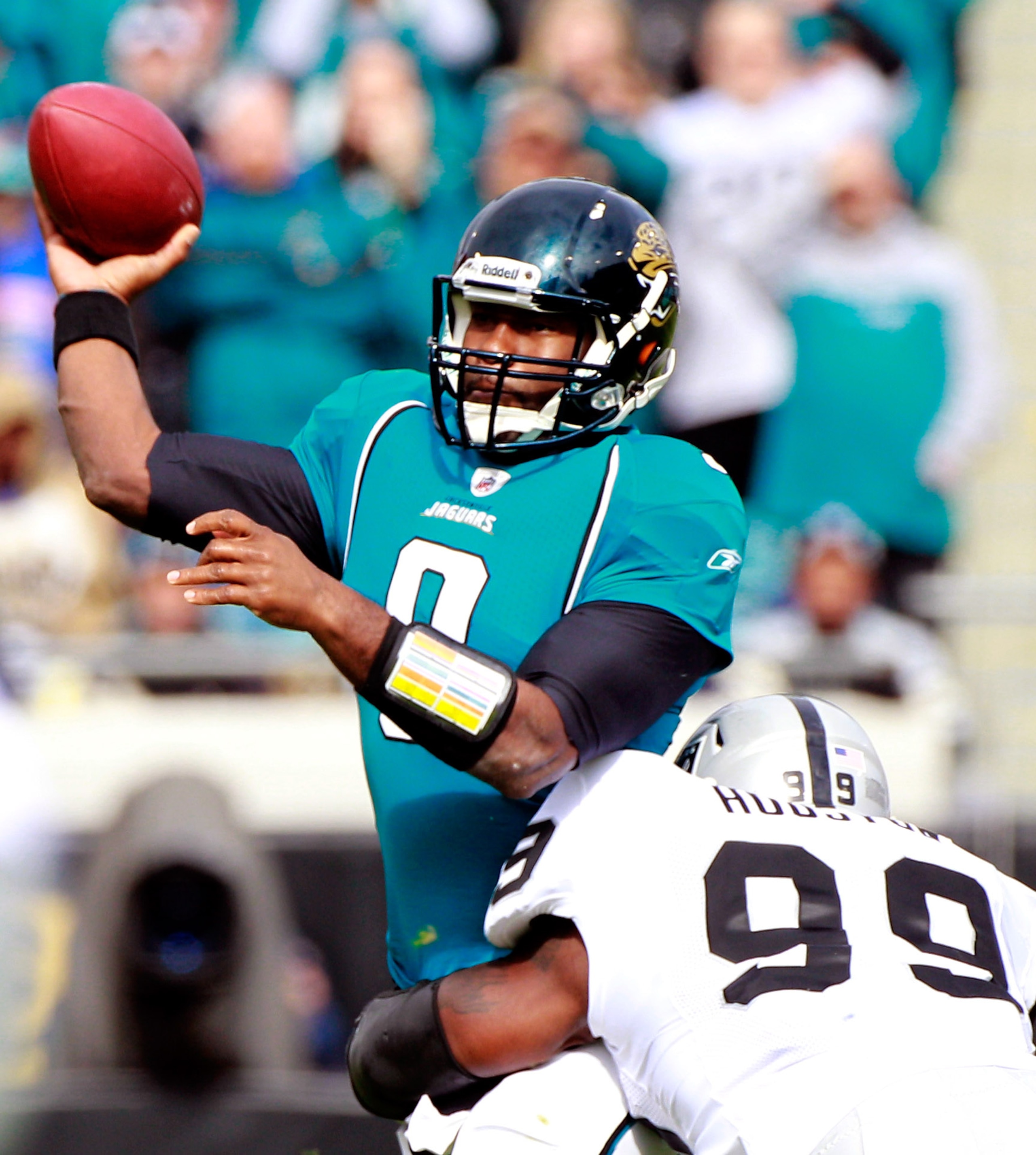 JACKSONVILLE, FL - DECEMBER 12:  Quarterback David Garrard #9 of the Jacksonville Jaguars attempts a pass while being pressured by Lamarr Houston #99 of the Oakland Raiders at EverBank Field on December 12, 2010 in Jacksonville, Florida.  (Photo by Sam Gr