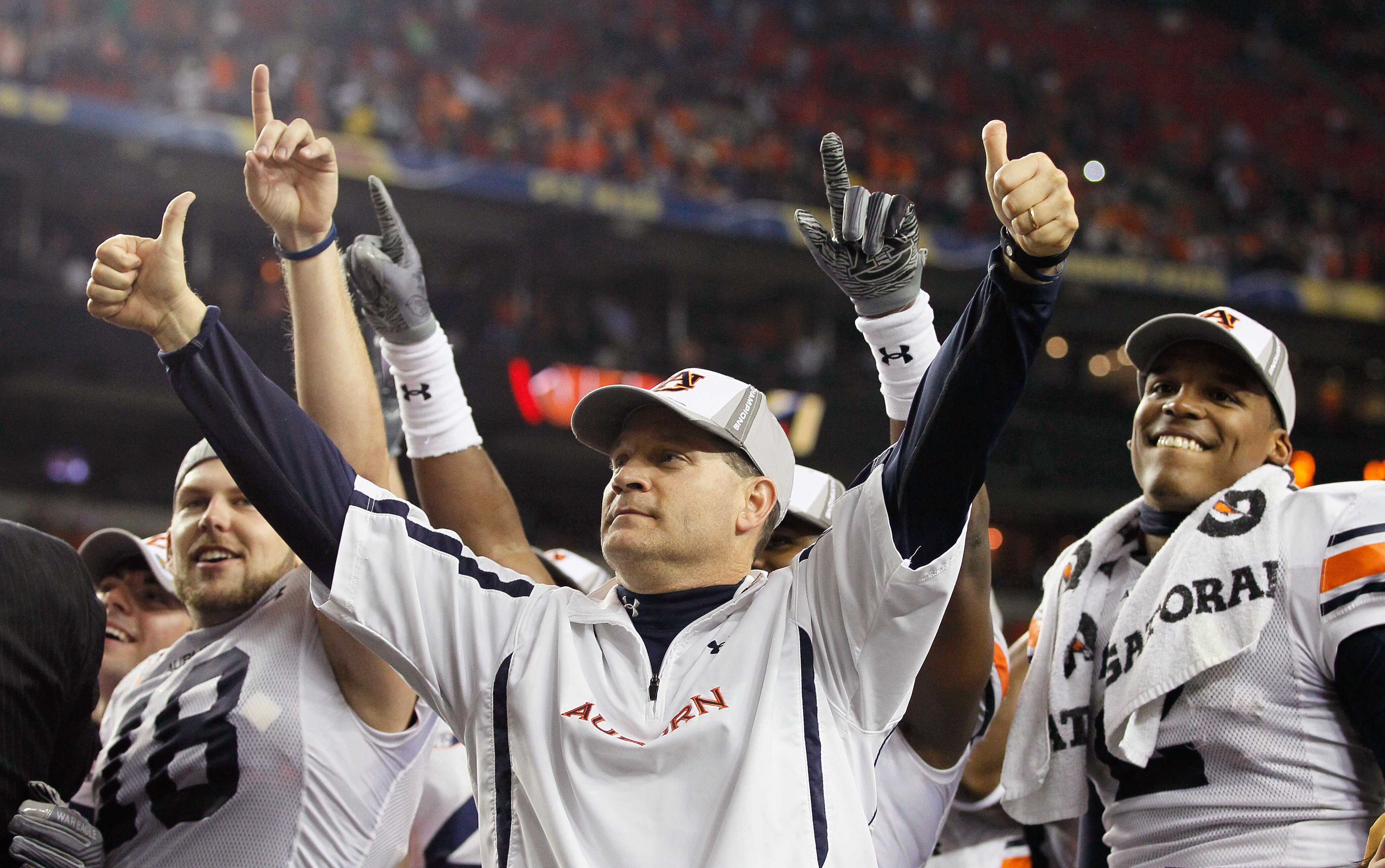 ATLANTA, GA - DECEMBER 04:  Head coach Gene Chizik and quarterback Cam Newton #2 of the Auburn Tigers celebrate after their 56-17 win over the South Carolina Gamecocks during the 2010 SEC Championship at Georgia Dome on December 4, 2010 in Atlanta, Georgi