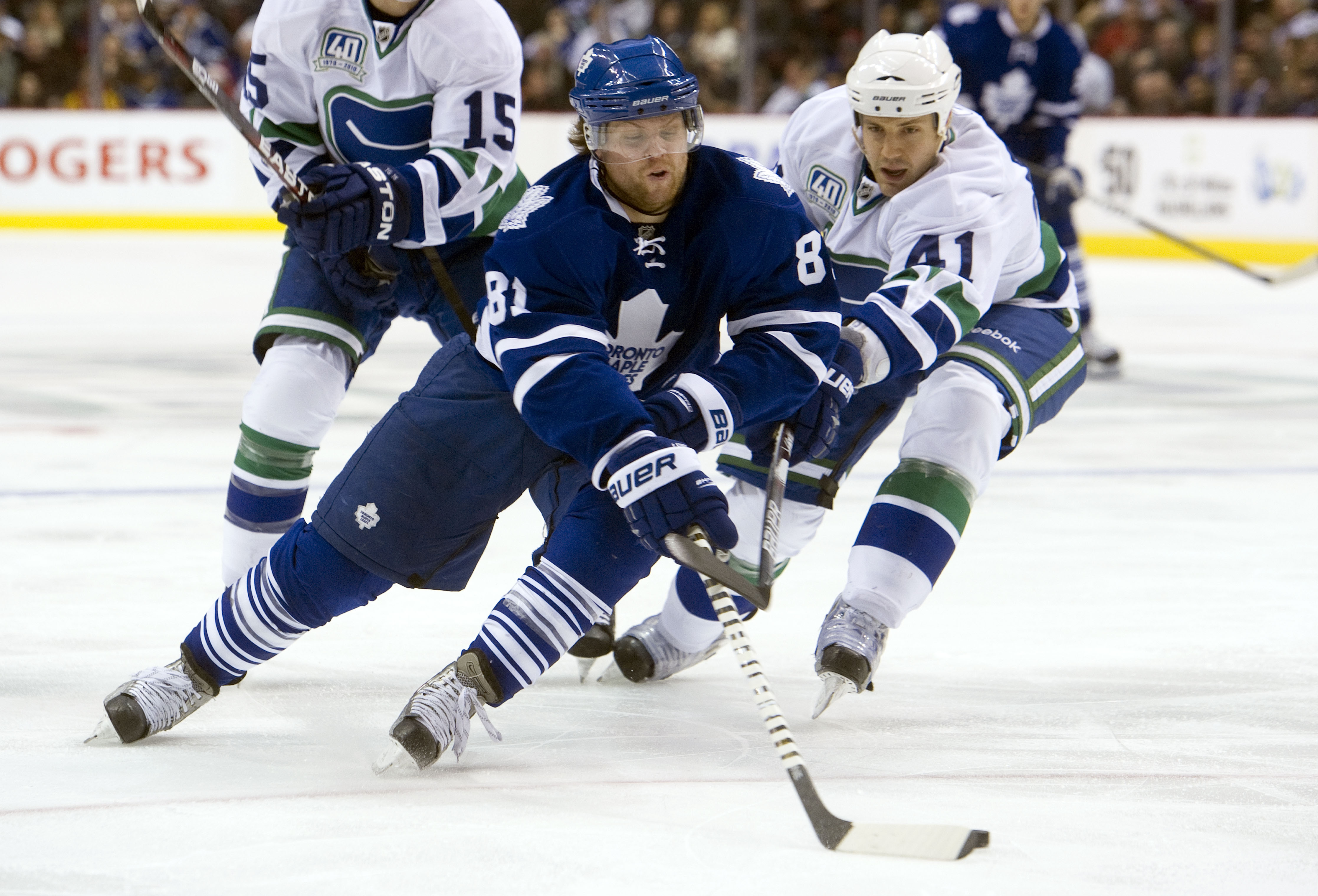 VANCOUVER, CANADA - DECEMBER 18: Andrew Alberts #41 of the Vancouver Canucks tries to check Phil Kessel #81 of the Toronto Maple Leafs during the third period in NHL action on December 18, 2010 at Rogers Arena in Vancouver, BC, Canada.  (Photo by Rich Lam