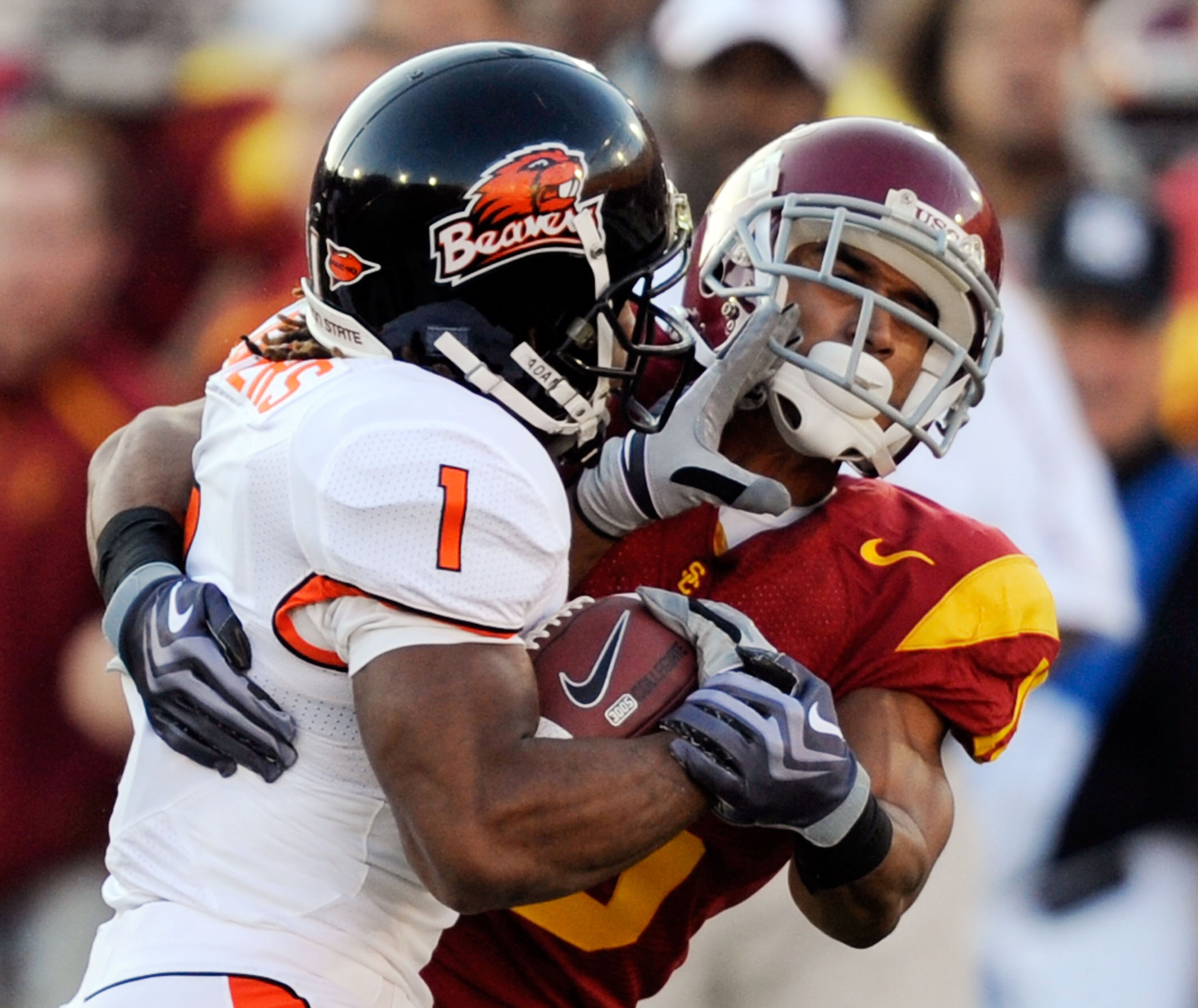 LOS ANGELES, CA - OCTOBER 24:  Jacquizz Rodgers #1 of the Oregon State Beavers is tackled by Kevin Thomas #15 of the USC Trojans for a four yard loss during the first quarter of the college football game at Los Angeles Memorial Coliseum on October 24, 200