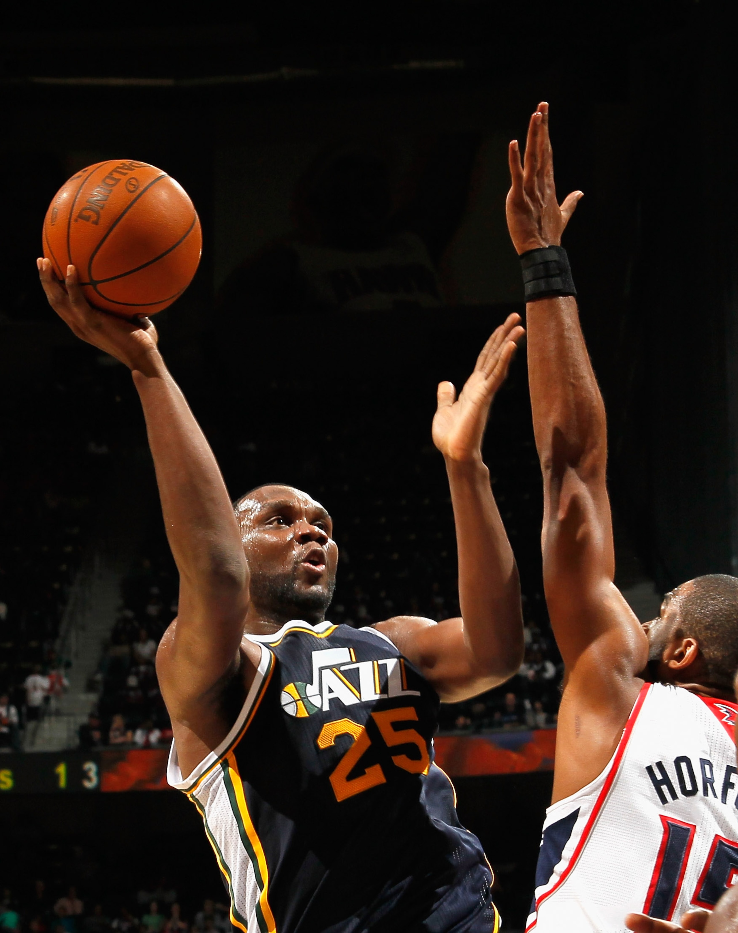 ATLANTA - NOVEMBER 12:  Al Jefferson #25 of the Utah Jazz against Al Horford #15 of the Atlanta Hawks at Philips Arena on November 12, 2010 in Atlanta, Georgia.  NOTE TO USER: User expressly acknowledges and agrees that, by downloading and/or using this P