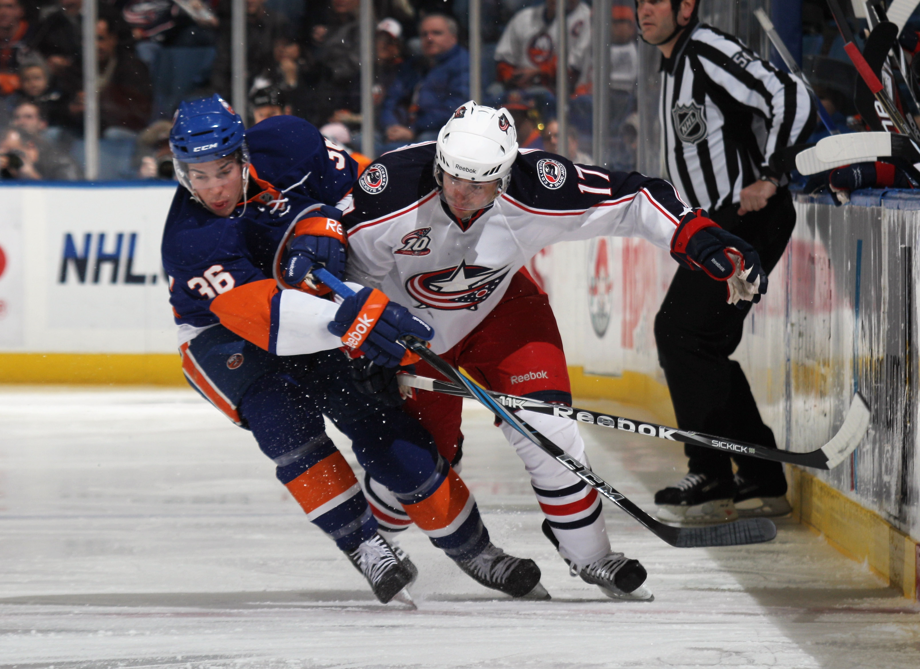 UNIONDALE, NY - NOVEMBER 24: Playing in his first NHL game, Travis Hamonic #36 of the New York Islanders holds up Andrew Murray #17 of the Columbus Blue Jackets at the Nassau Coliseum on November 24, 2010 in Uniondale, New York.  (Photo by Bruce Bennett/G