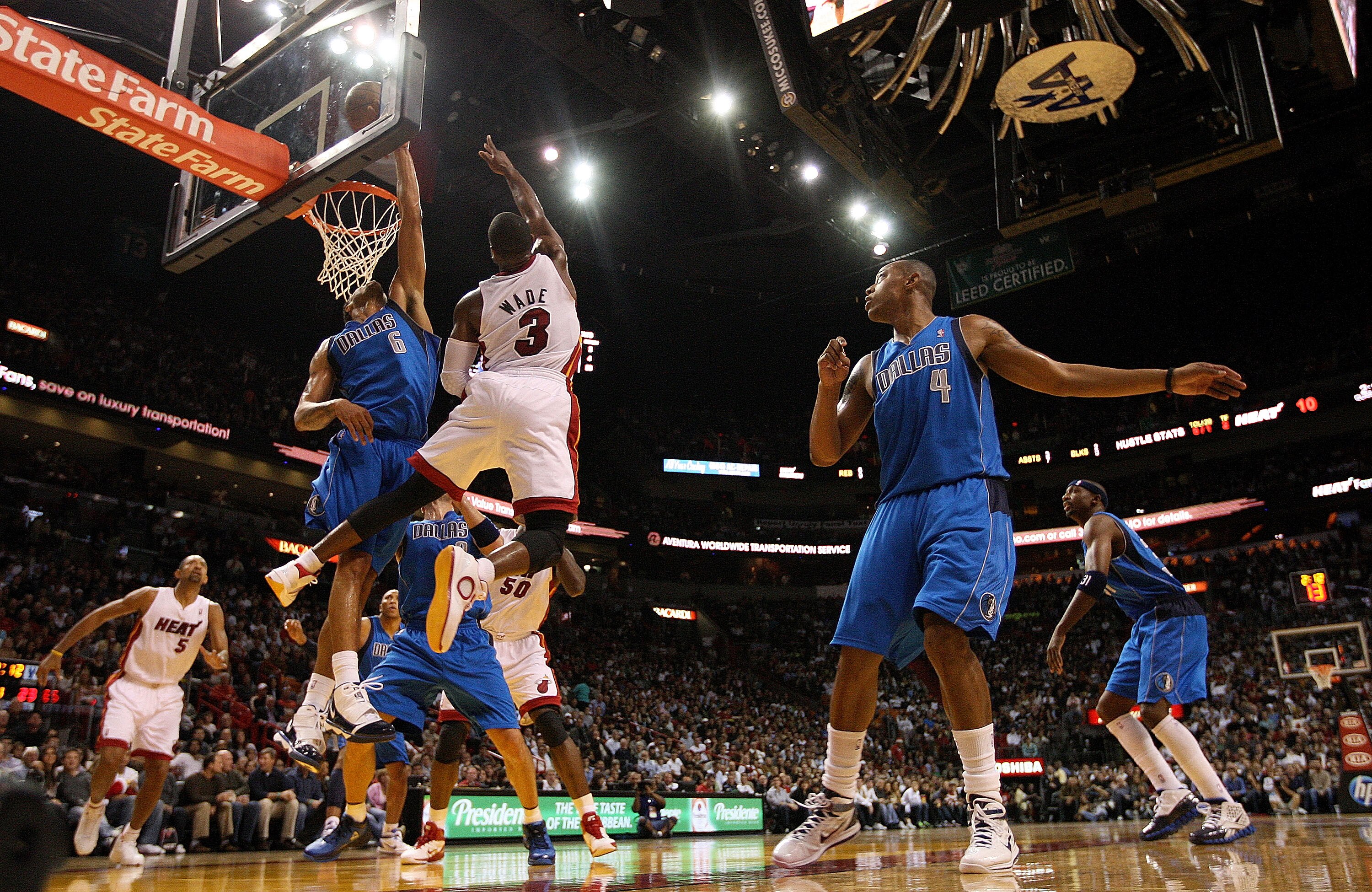 MIAMI, FL - DECEMBER 20:  Dwyane Wade #3 of the Miami Heat drives past Tyson Chandler #6 of the Dallas Mavericks during a game at American Airlines Arena on December 20, 2010 in Miami, Florida. NOTE TO USER: User expressly acknowledges and agrees that, by