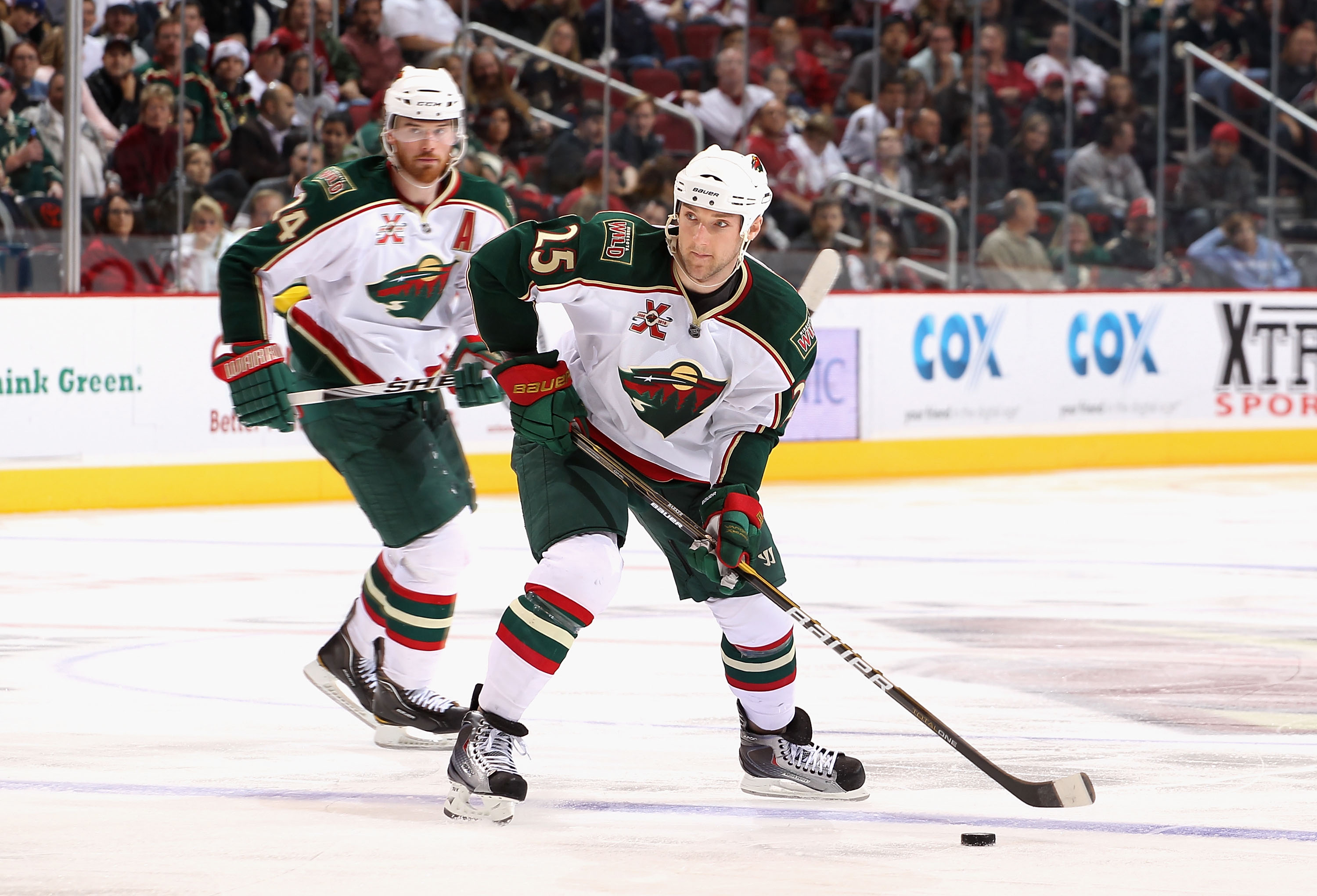 GLENDALE, AZ - DECEMBER 09:  Cam Barker #25 of the Minnesota Wild skates with the puck during the NHL game against the Phoenix Coyotes at Jobing.com Arena on December 9, 2010 in Glendale, Arizona.  The Wild defeated the Coyotes 3-2.  (Photo by Christian P