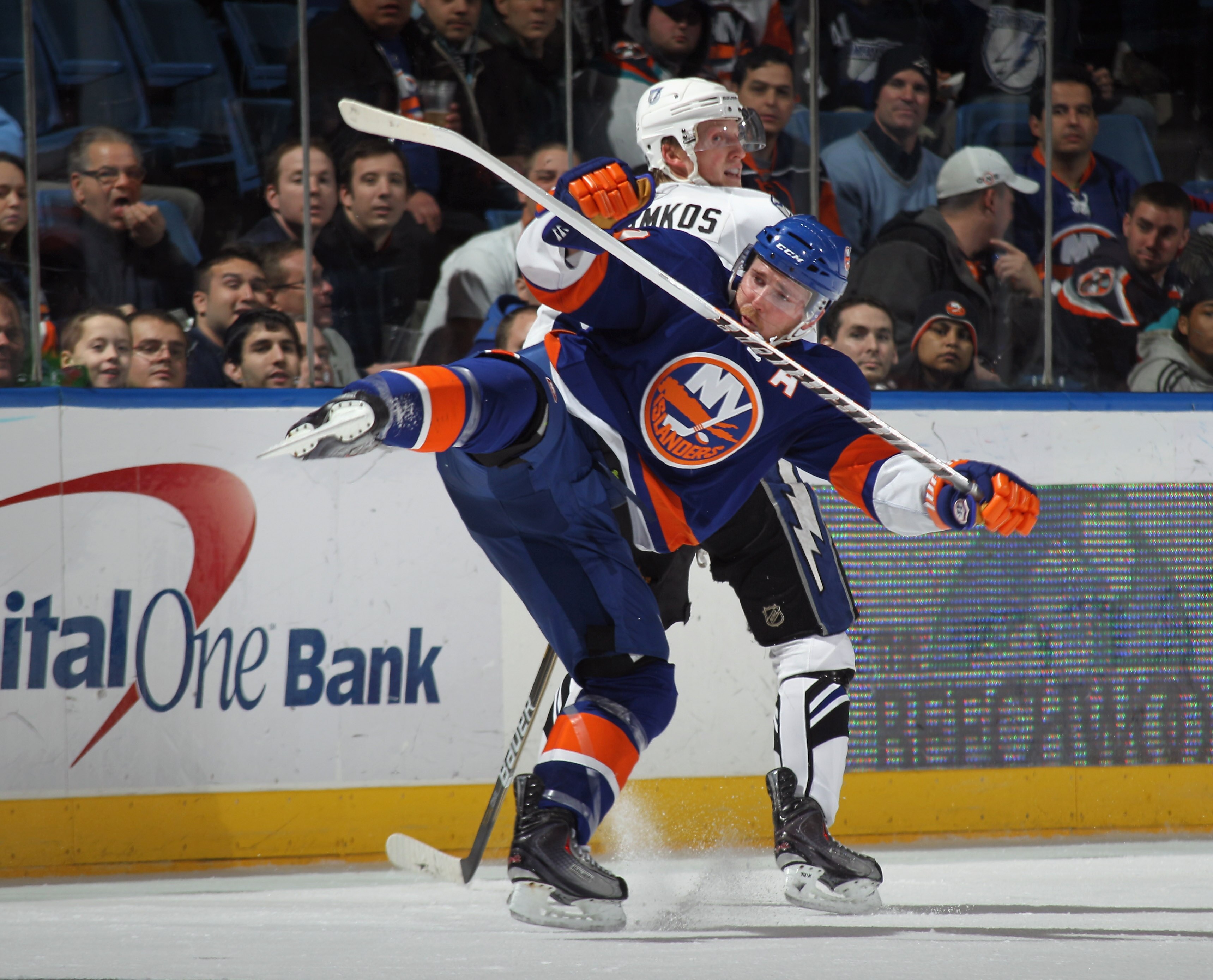 UNIONDALE, NY - DECEMBER 22: James Wisniewski #20 of the New York Islanders is tripped up by Steven Stamkos #91 of the Tampa Bay Lightning at the Nassau Coliseum on December 22, 2010 in Uniondale, New York. (Photo by Bruce Bennett/Getty Images)