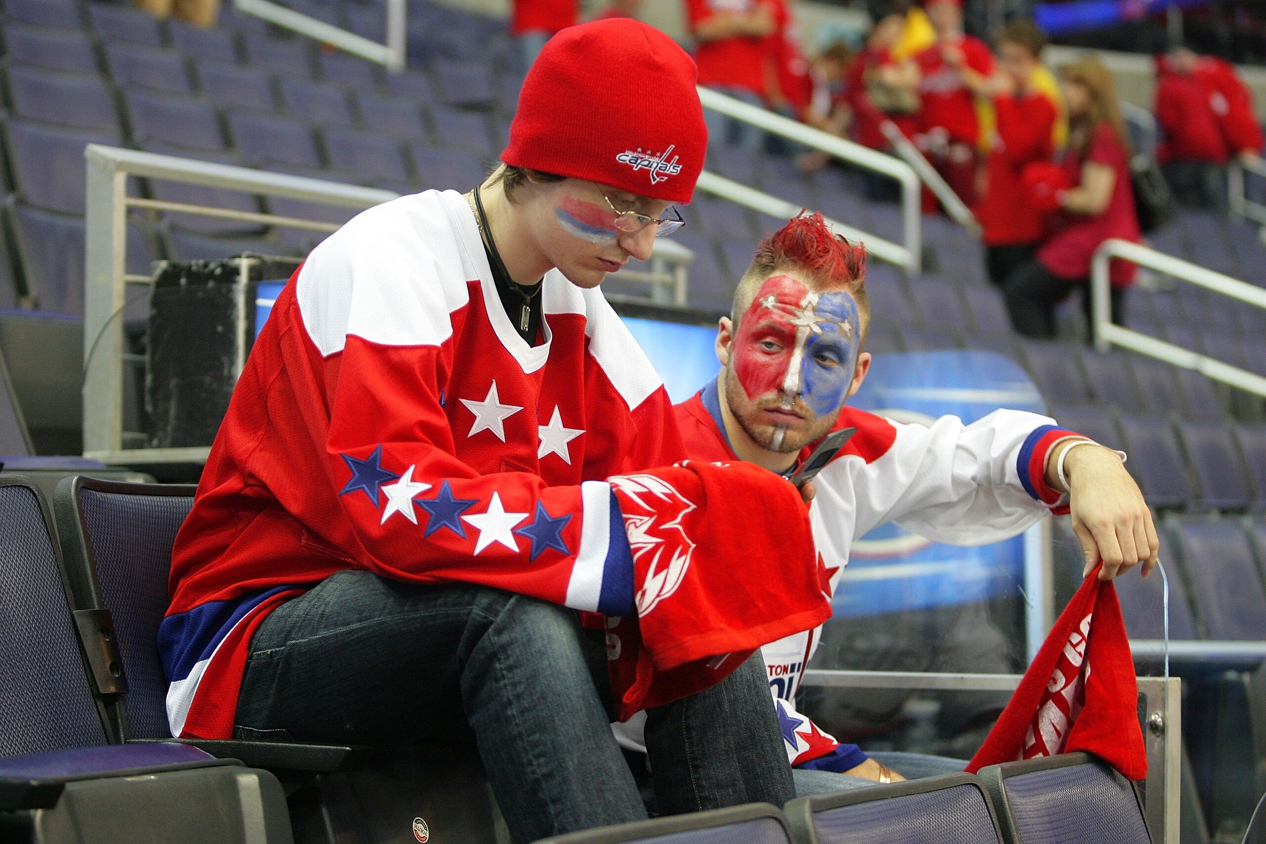 WASHINGTON - APRIL 22:  Two disappointed fans of the Washington Capitals sit dejected after the overtime loss against the Philadelphia Flyers during game seven of the Eastern Conference Quarterfinals of the 2008 NHL Stanley Cup Playoffs on April 22, 2008
