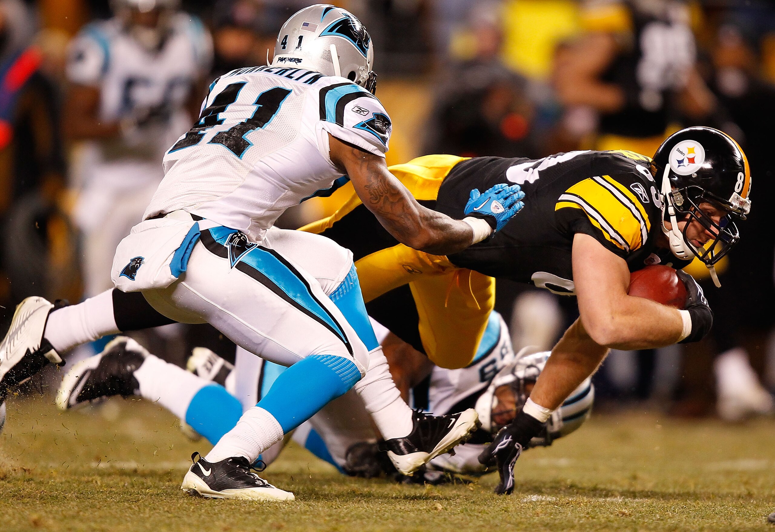 PITTSBURGH - DECEMBER 23:  Heath Miller #83 of the Pittsburgh Steelers dives after making a catch in front of Captain Munnerlyn #41 of the Carolina Panthers during the game on December 23, 2010 at Heinz Field in Pittsburgh, Pennsylvania.  (Photo by Jared