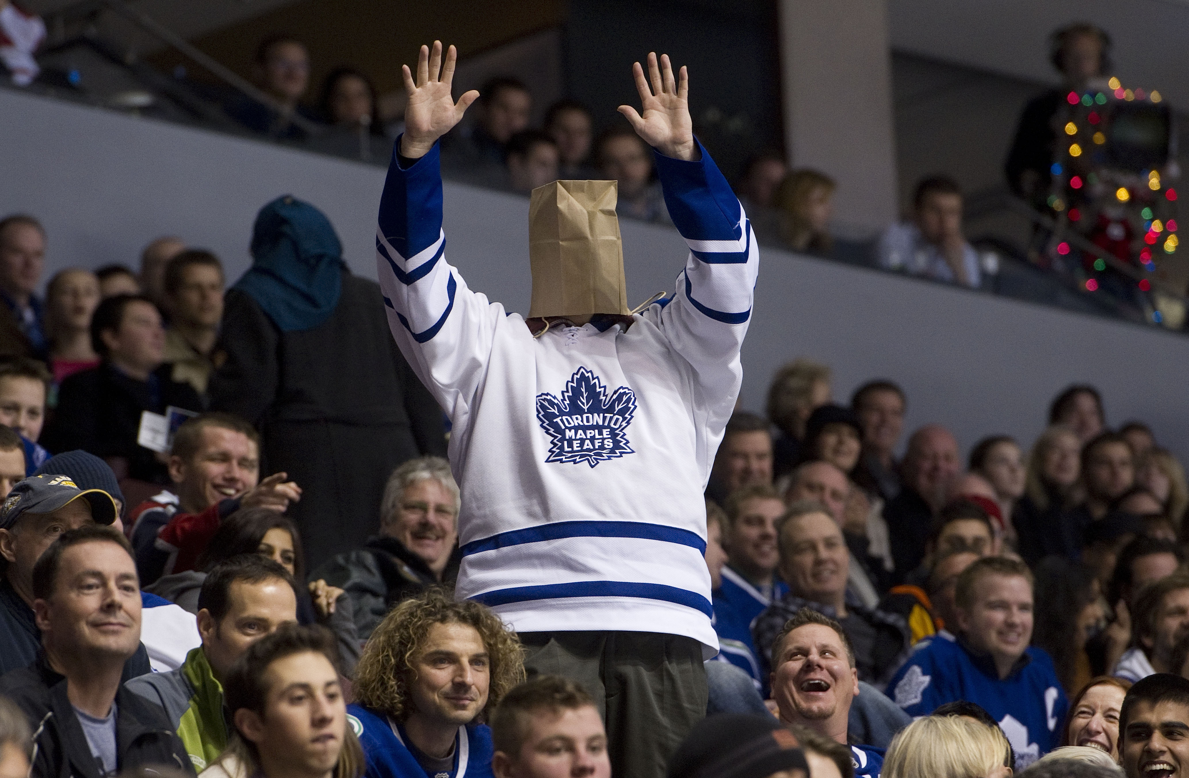 VANCOUVER, CANADA - DECEMBER 18: A Toronto Maple Leafs fans cheers during the late stages of the third period in NHL action on December 18, 2010 between the Vancouver Canucks and the Maple Leafs at Rogers Arena in Vancouver, BC, Canada.  (Photo by Rich La