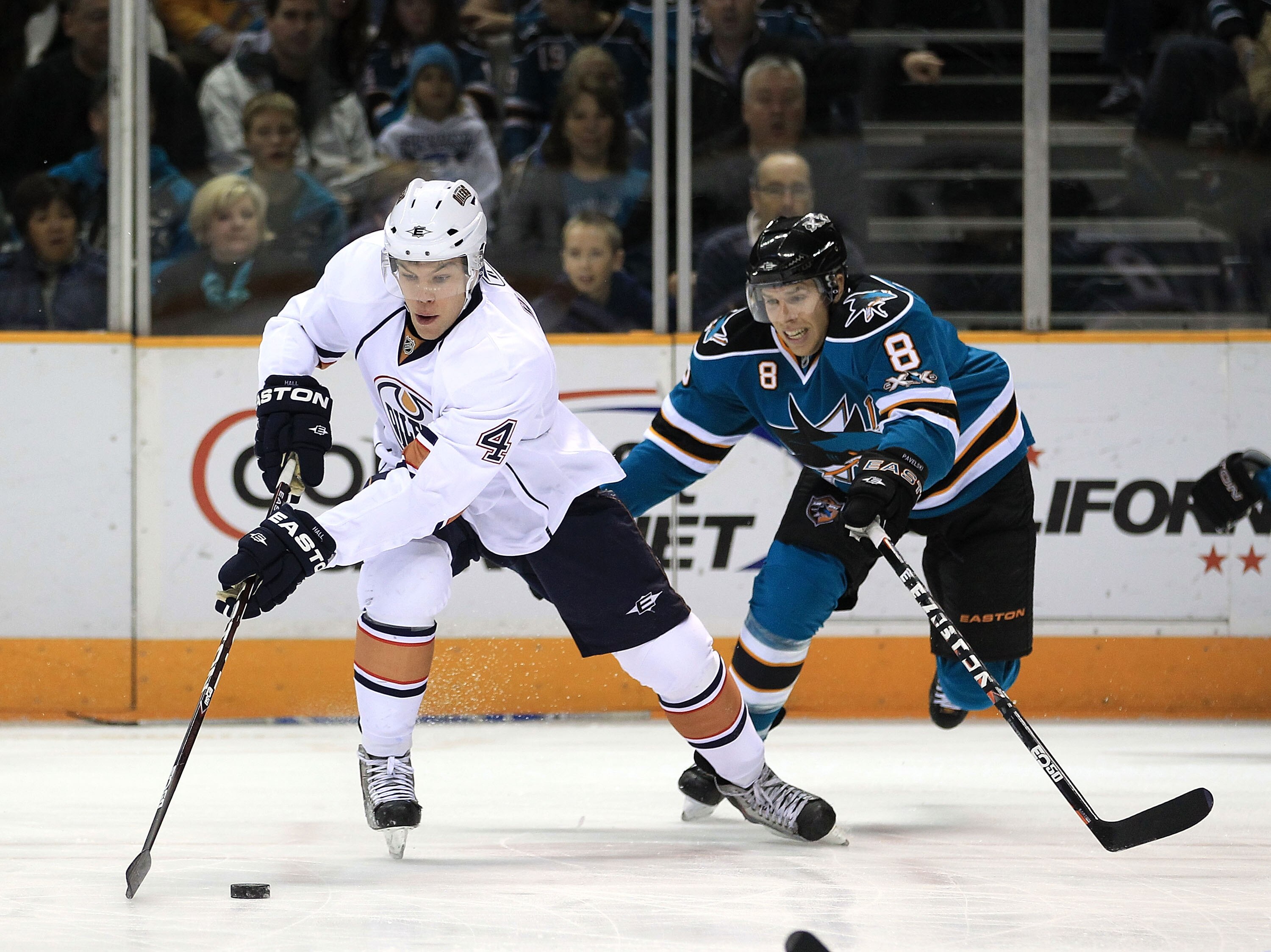 SAN JOSE, CA - DECEMBER 21:  Taylor Hall #4 of the Edmonton Oilers and Joe Pavelski #8 of the San Jose Sharks go for the puck at HP Pavilion on December 21, 2010 in San Jose, California.  (Photo by Ezra Shaw/Getty Images)
