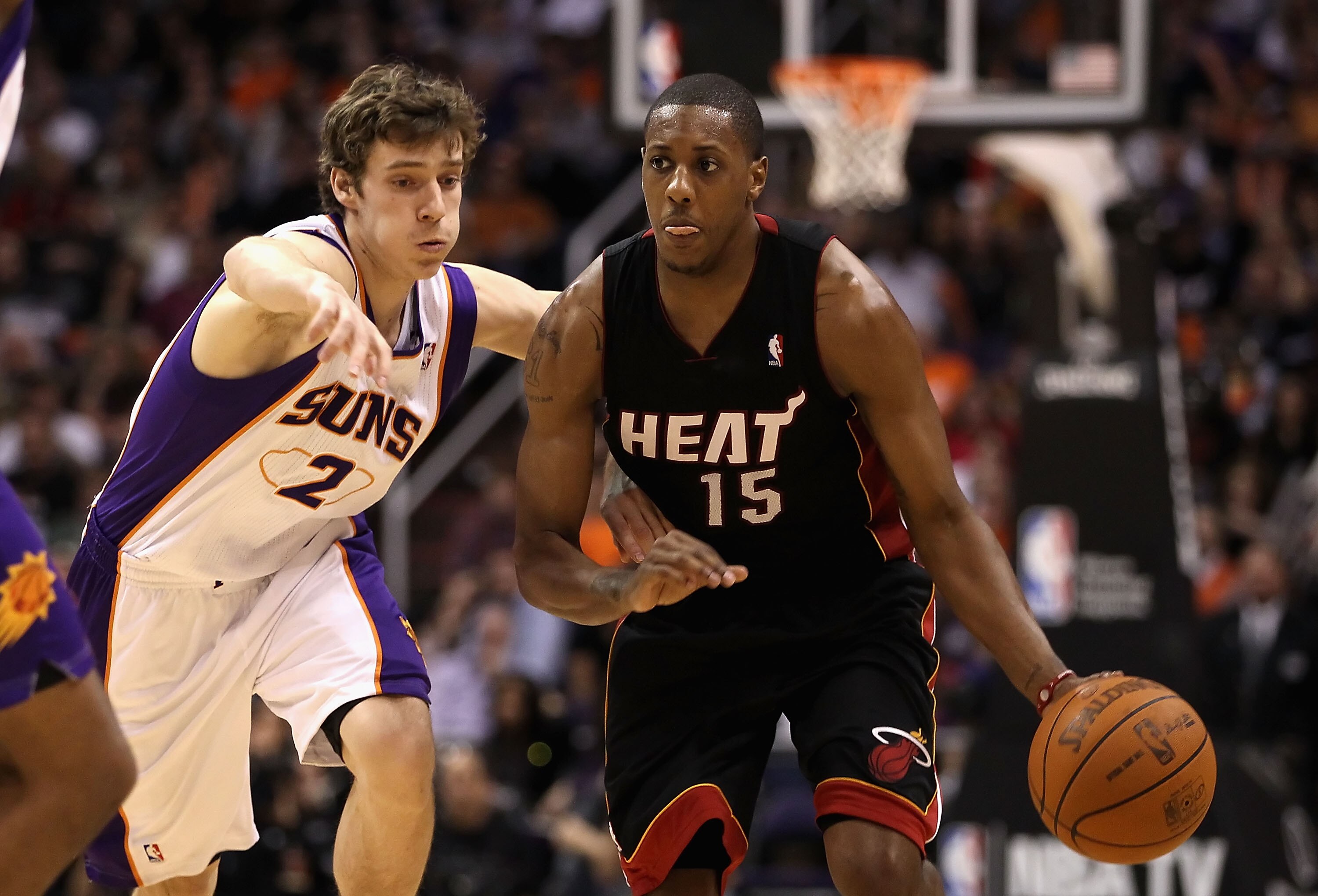 PHOENIX - DECEMBER 23:  Mario Chalmers #15 of the Miami Heat drives the ball past Goran Dragic #2 of the Phoenix Suns during the NBA game at US Airways Center on December 23, 2010 in Phoenix, Arizona. The Heat defeated the Suns 95-83.  NOTE TO USER: User
